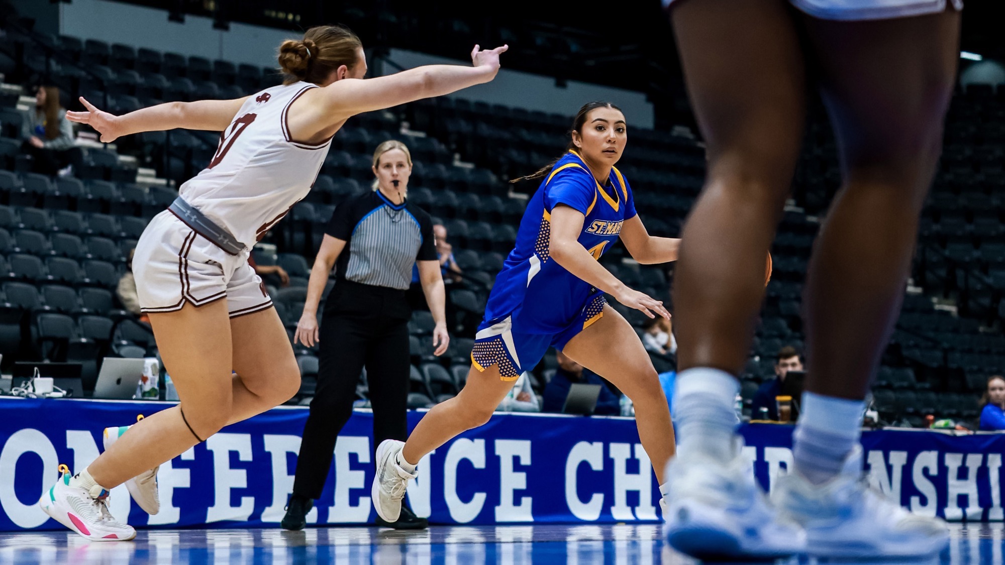 Brianna Vargas dribbles the basketball with her left hand around the perimeter as she is guarded by a WT player.