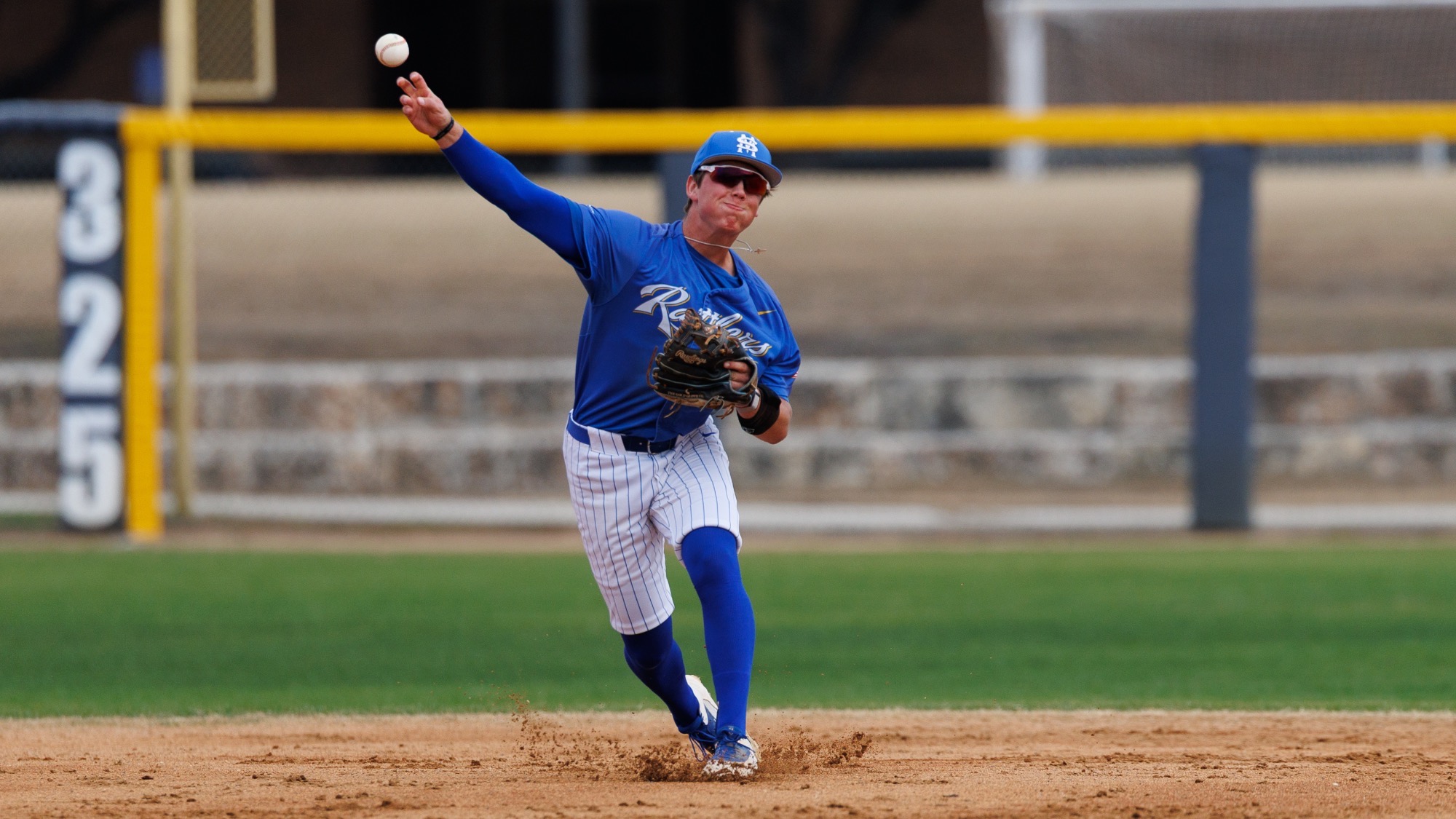 Blake Allen plants his feet as the throws the ball from short stop to first base.