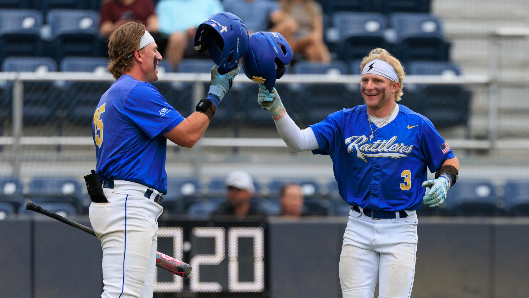 Garrett Brooks and Ashton Beaird click helmets at home plate after Beaird hit a home run against Cameron.