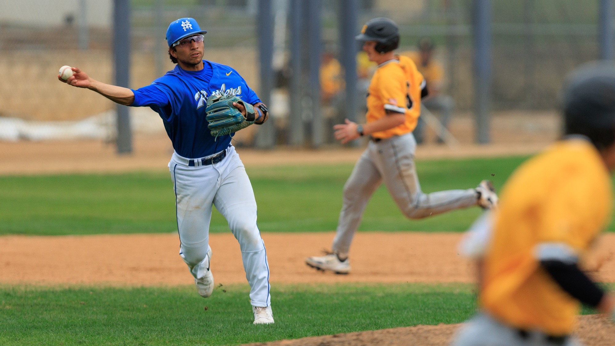 Matt Mendez throws the ball from the left side of the infield to first base.
