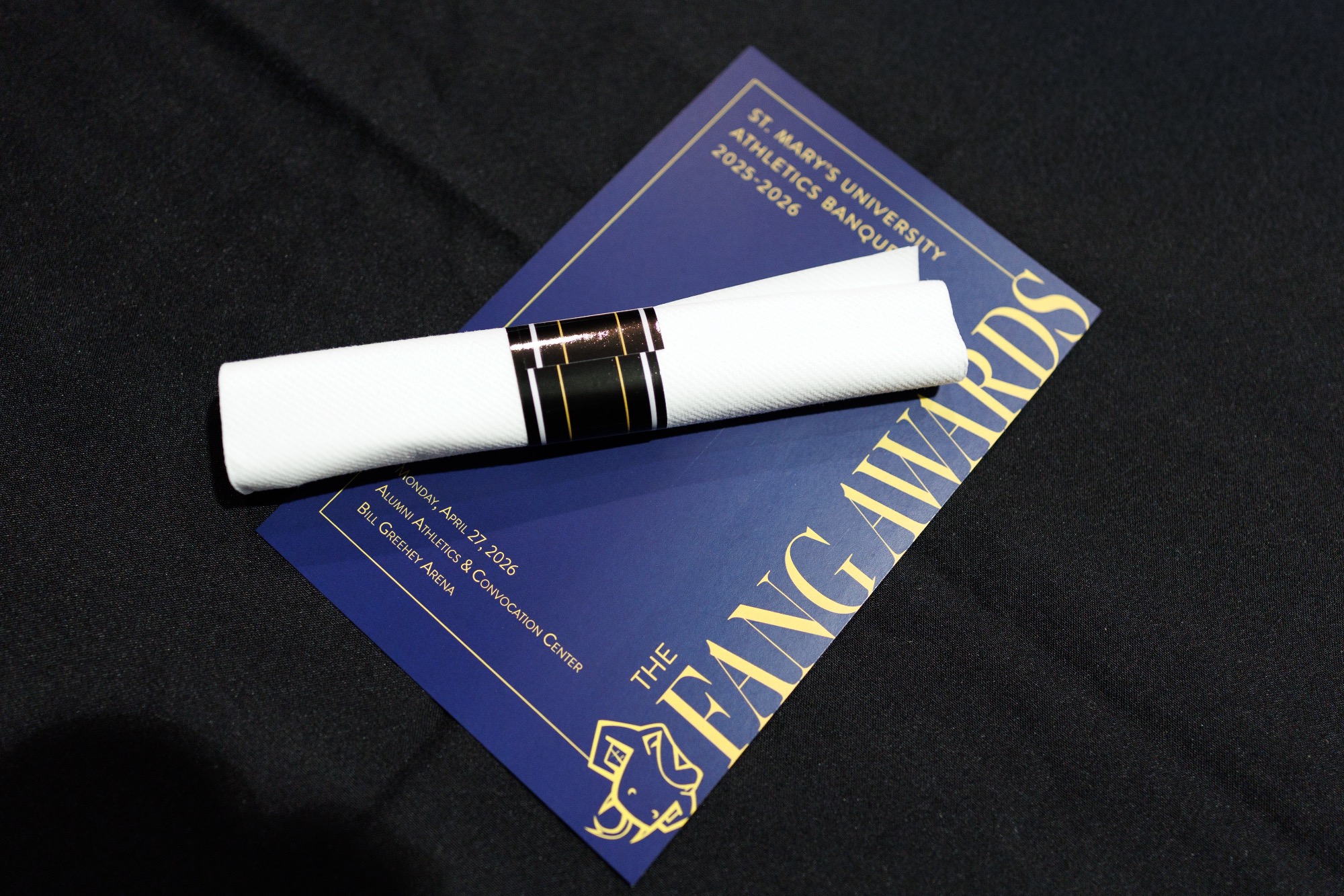 Program with rolled napkin on table