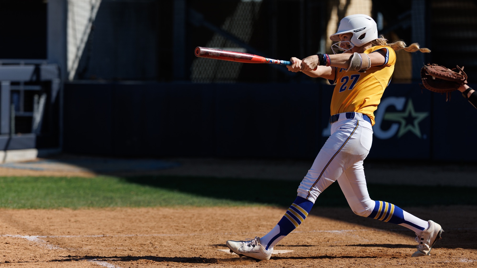 Raegan Tennill hits the softball.