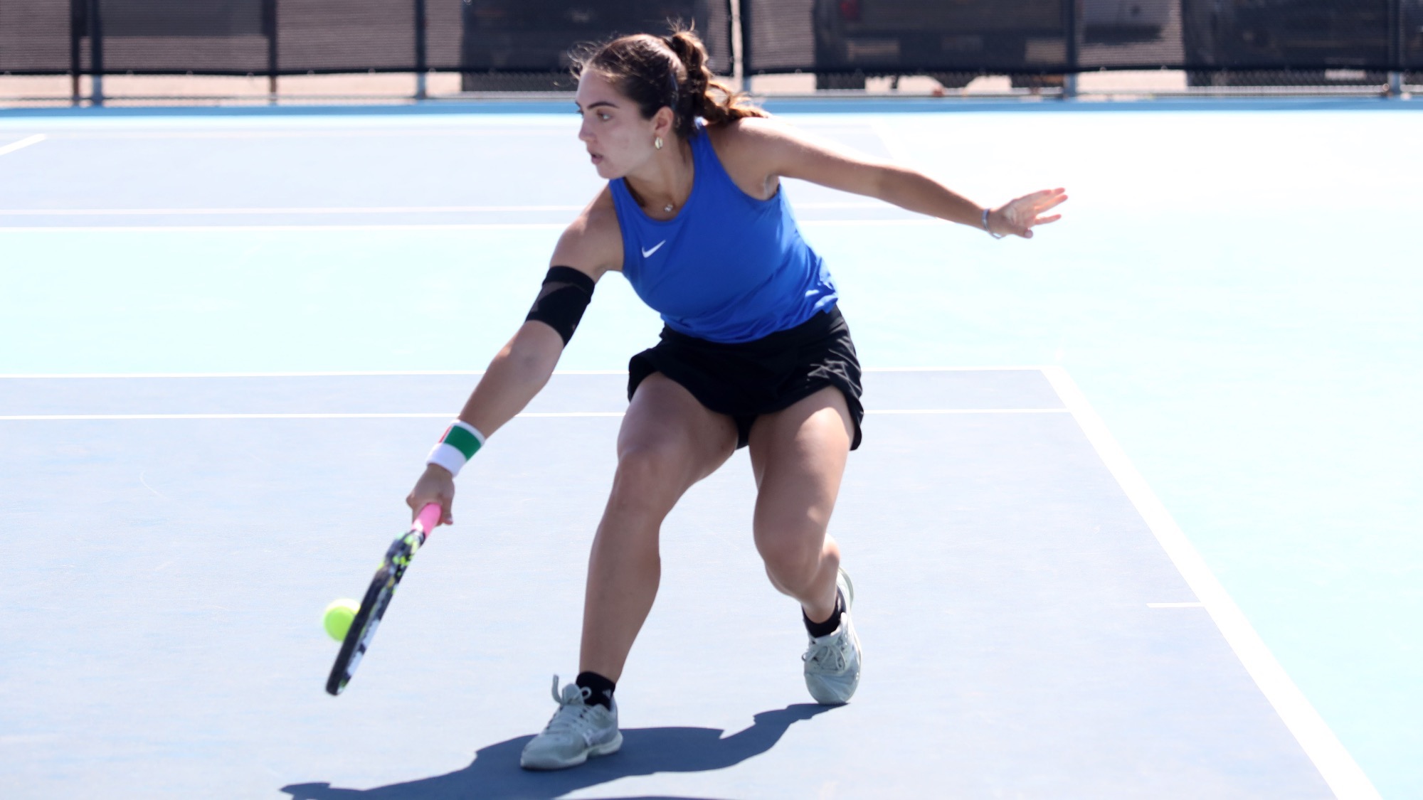Alessia Terlizzi goes low to hit a one-handed backhand at Lubbock Christian.