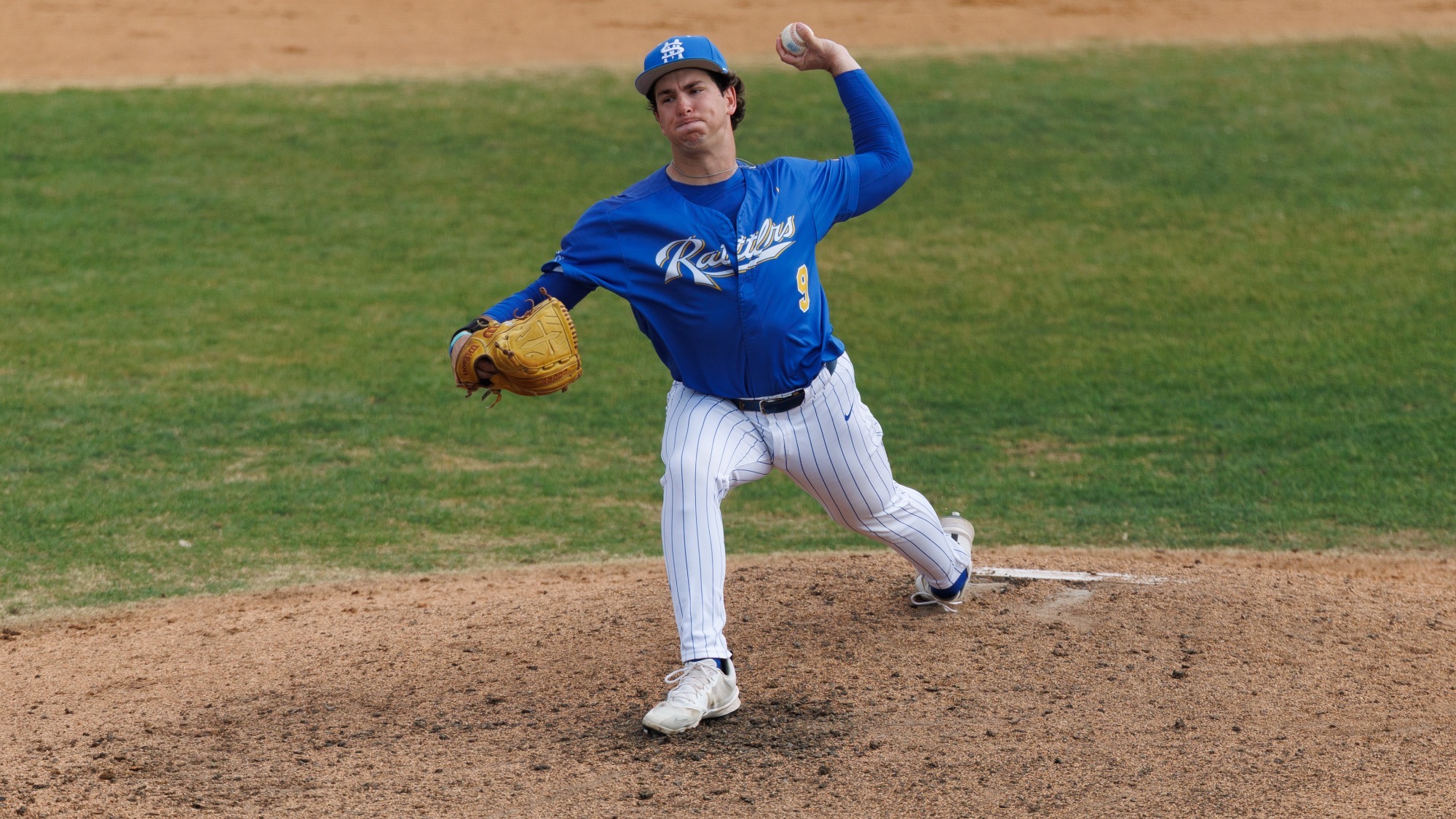 Eric Tenery throws a pitch to home plate.