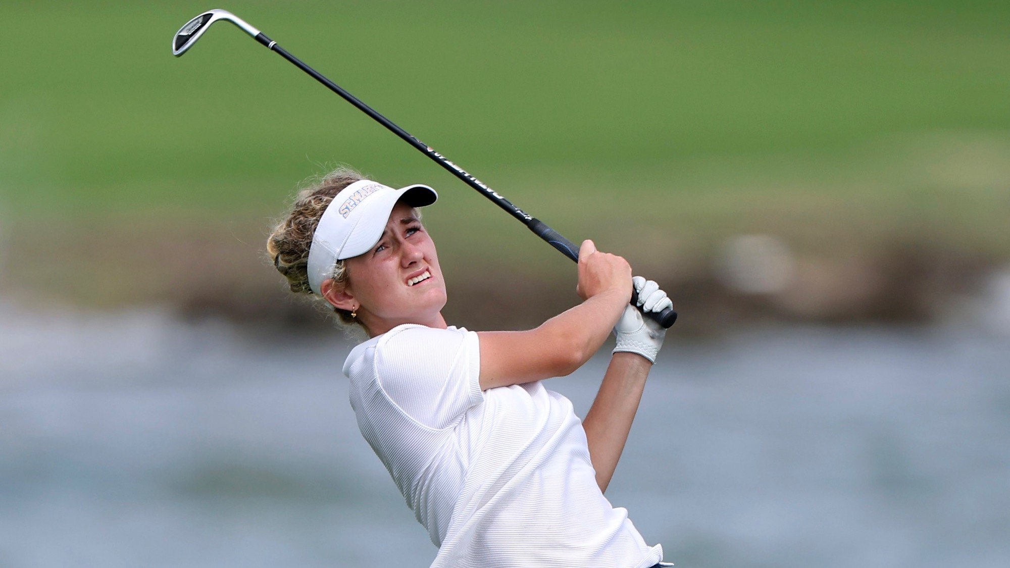 Brielle Burns watches the flight of her ball 