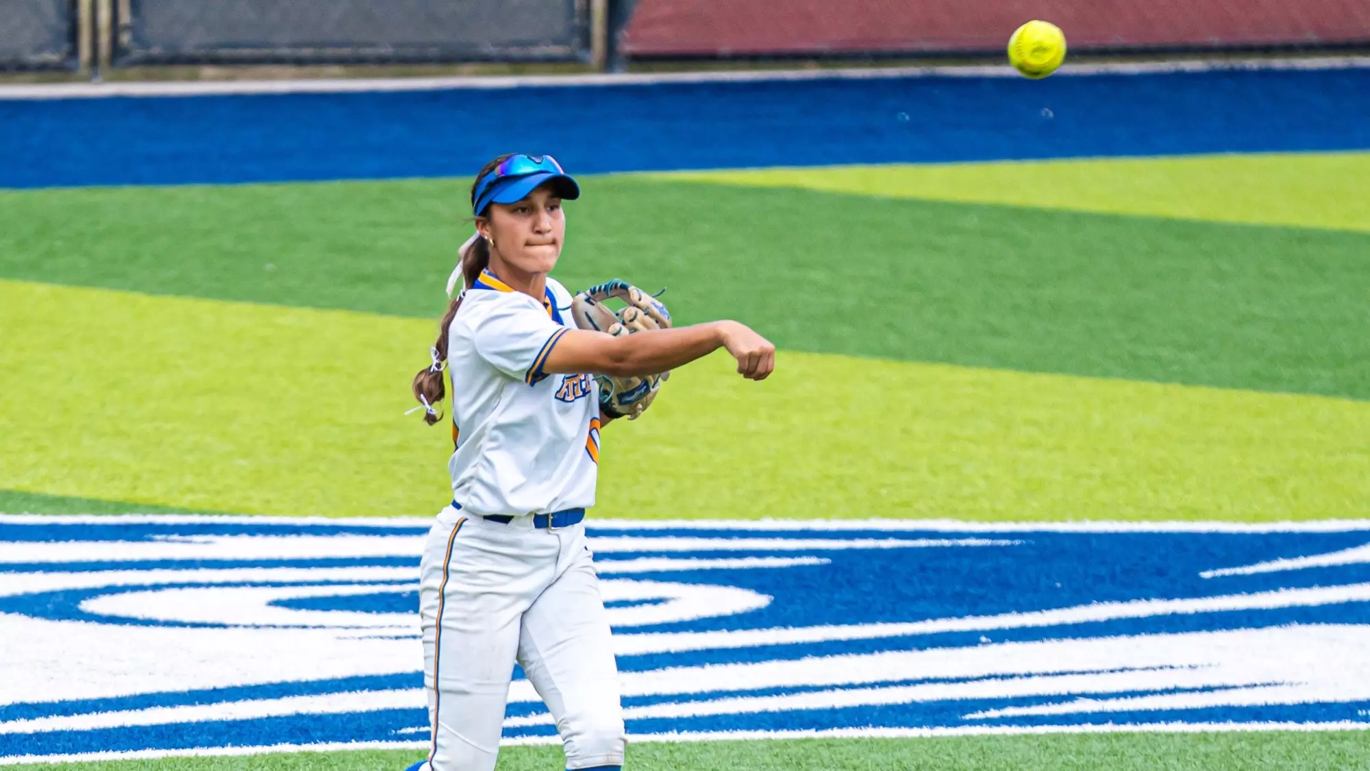 Abby Dela Rosa throws a ball in from centerfield.