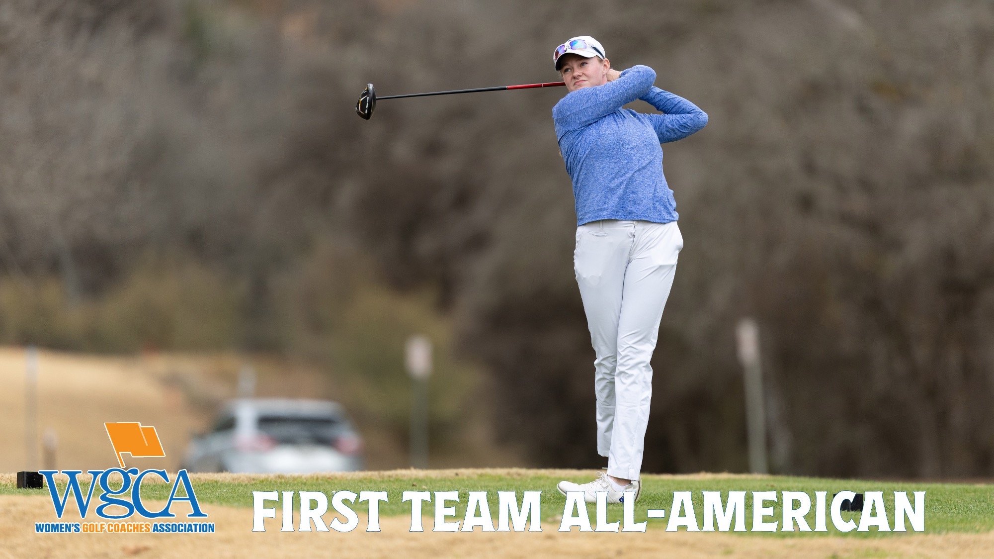 Taylor Wilczek watches the flight of her ball after teeing off. In the bottom left corner is the WGCA logo with the words First-Team All-American to the right of it.