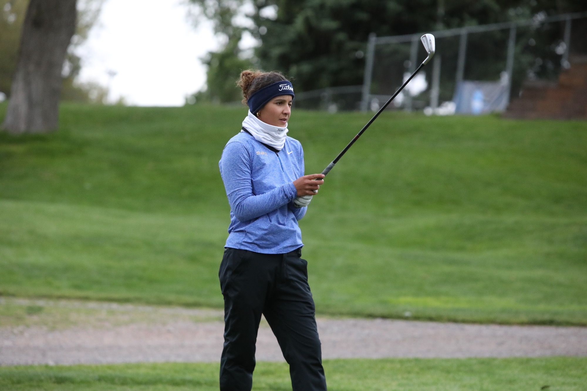 Manon Verret holds her driver out in front of her, lining up the shot at the tee box at the Pueblo Country Club.