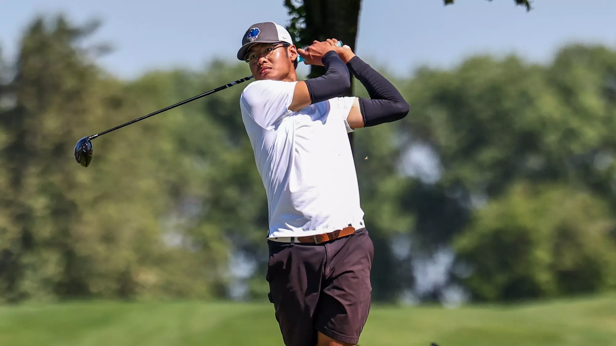 Kongpop Kaikaew watches the flight of his ball after teeing off.