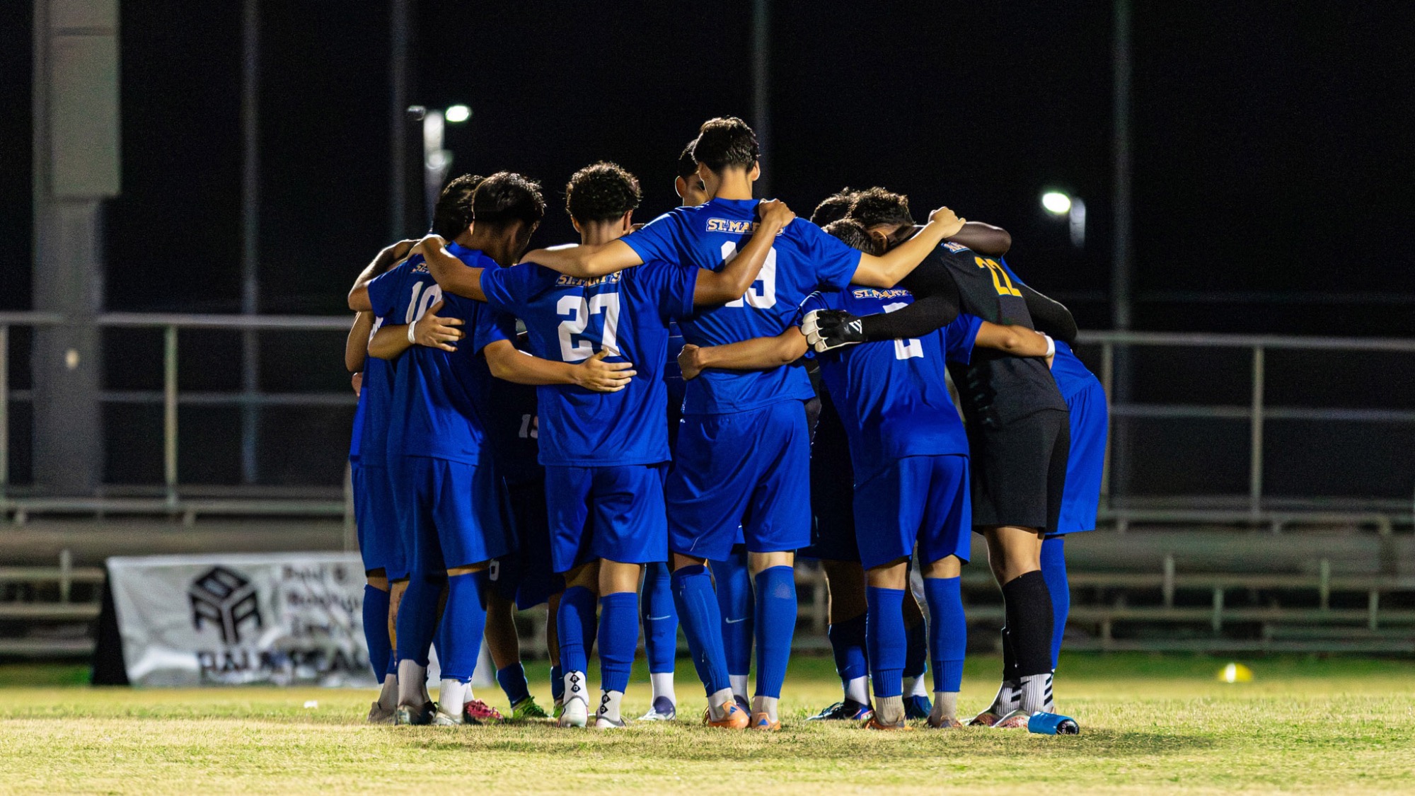 The men's soccer team huddles before the start of the second half in the season opener.