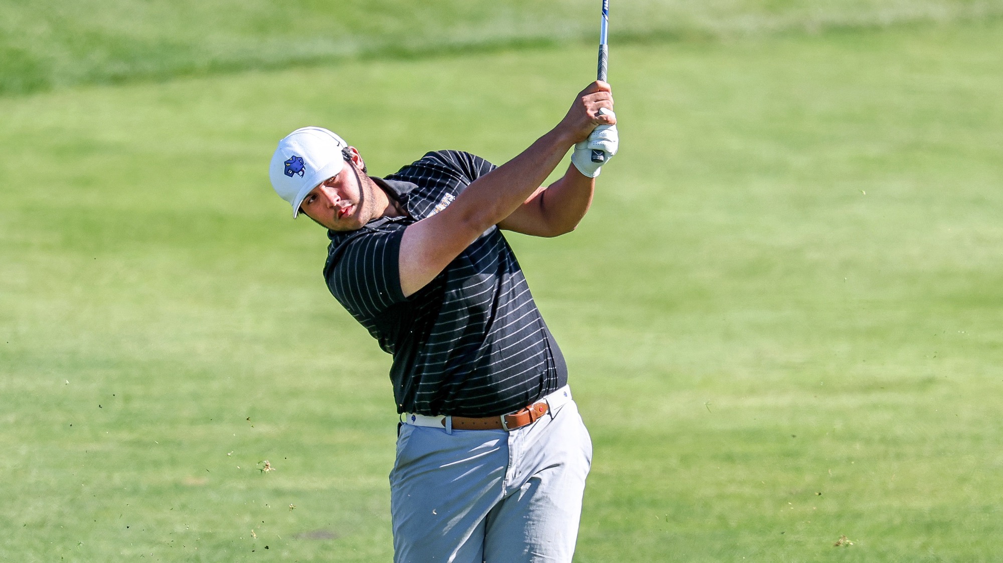 Elijah Galvan follows the flight of his ball after hitting a shot.
