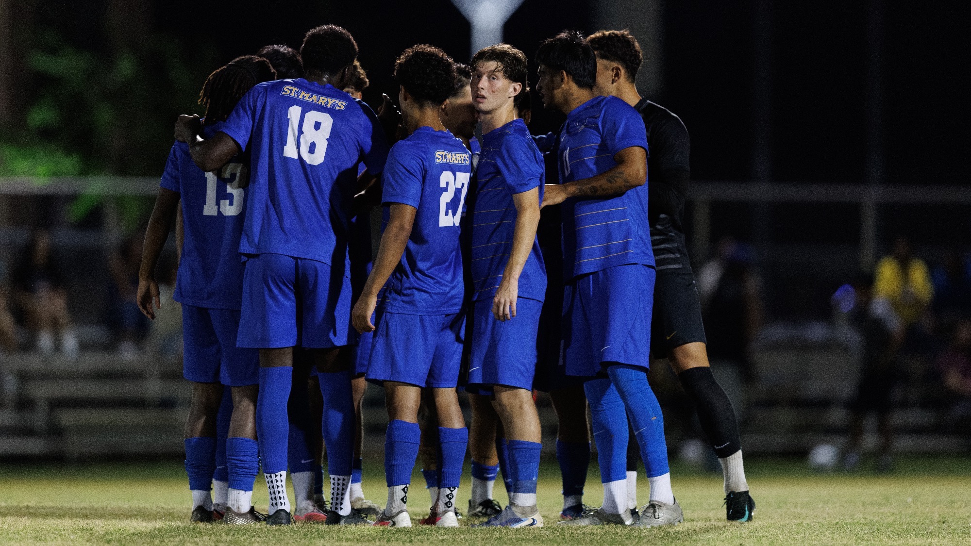 The team huddles on the pitch before the start of the second half against Texas A&M San Antonio