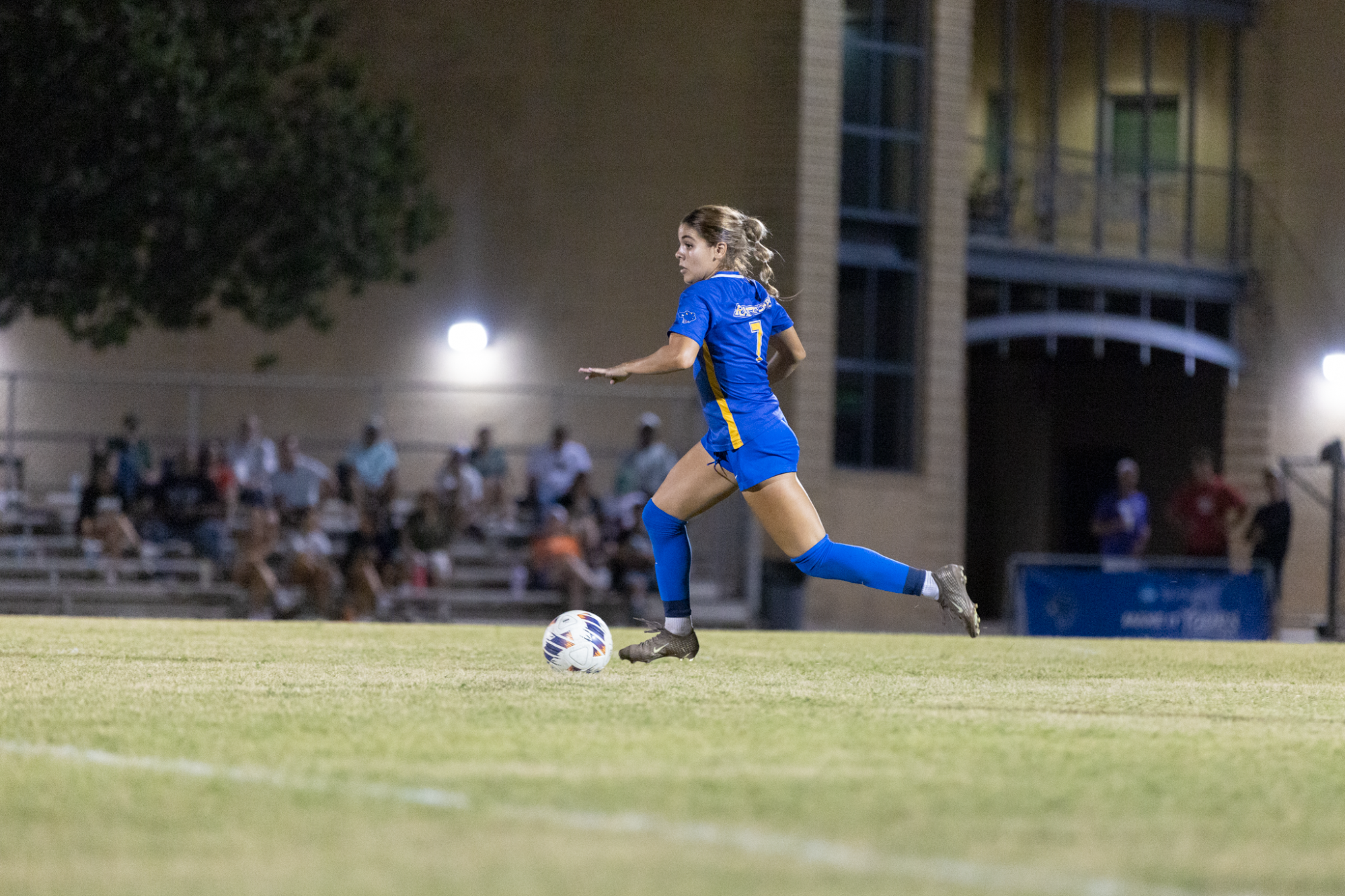 Helenz Lazaro kicks the ball from midfield.