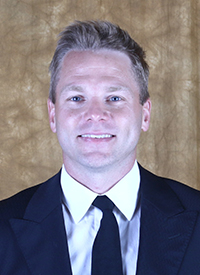 A headshot of St. Olaf Assistant Football Coach Tom Menke.