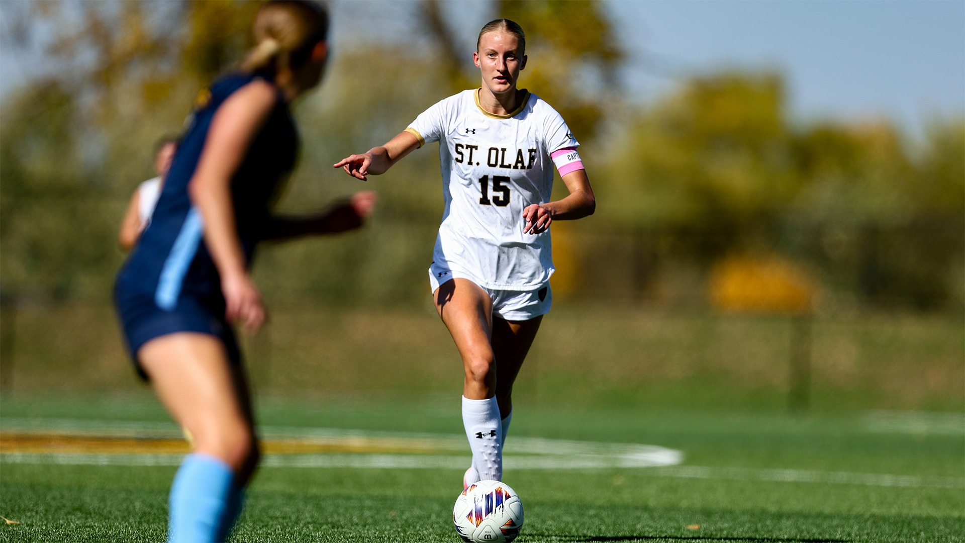 Emily Johnson dribbles the ball forward.