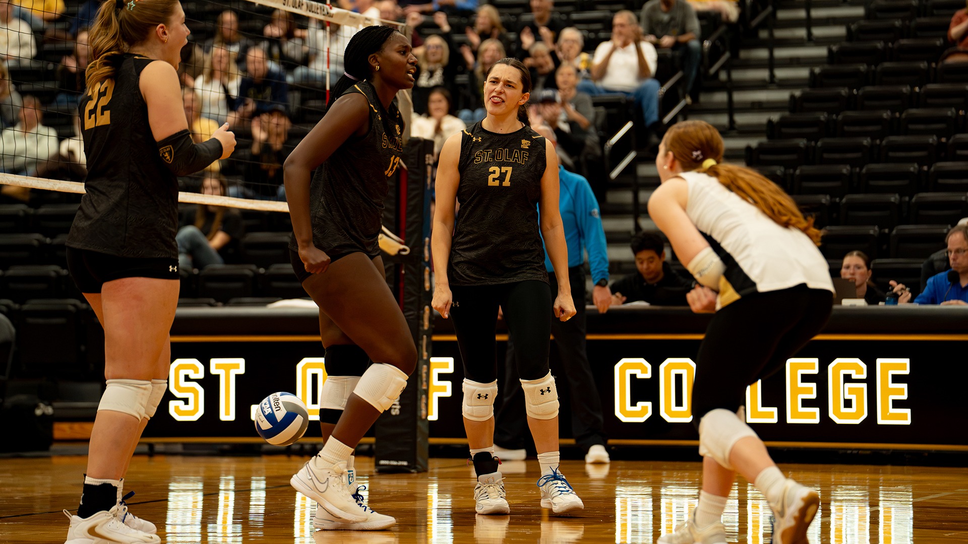 St. Olaf celebrates winning a point.