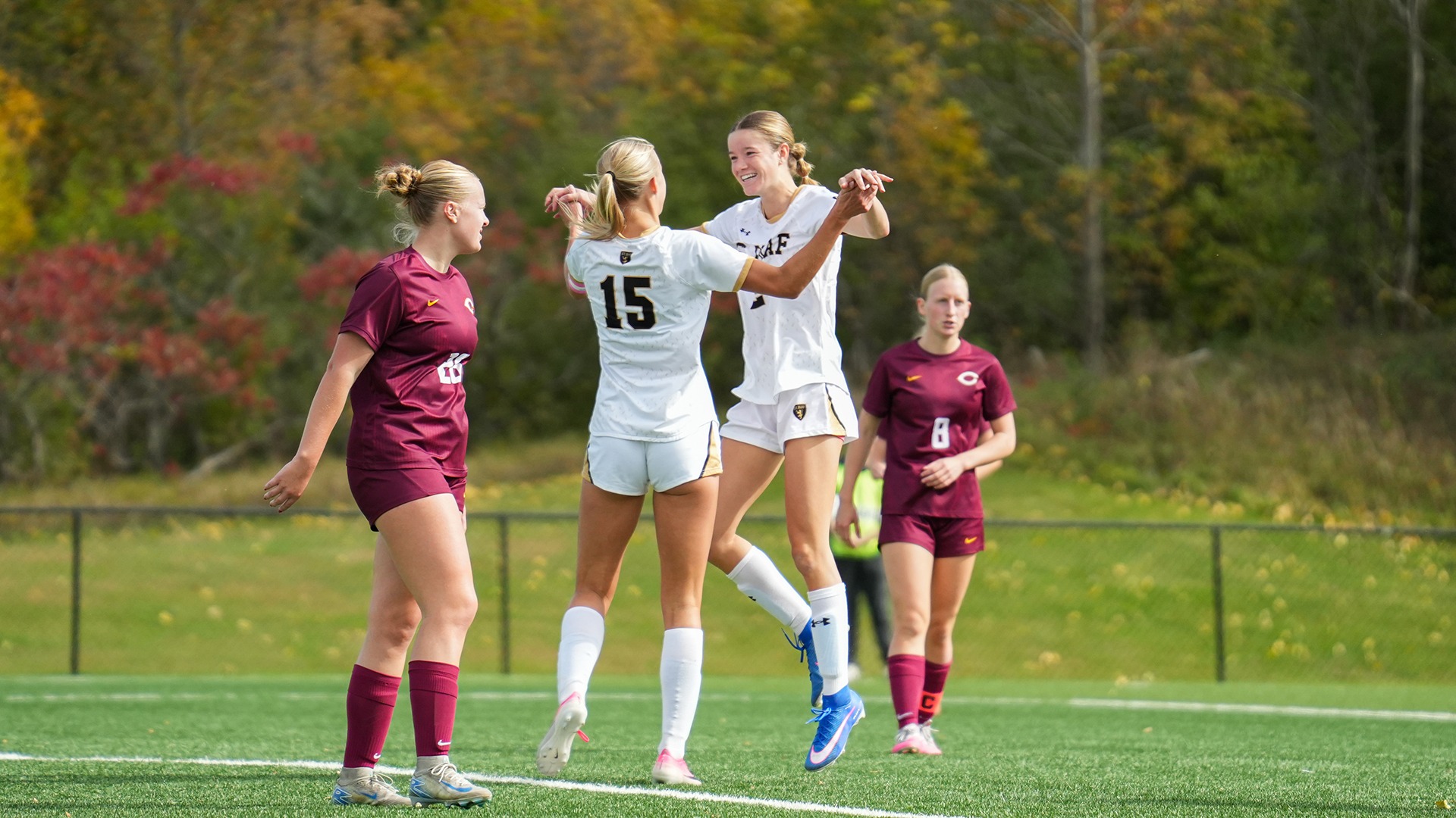 Rachel Anderson and Emily Johnson celebrate Johnson's goal.