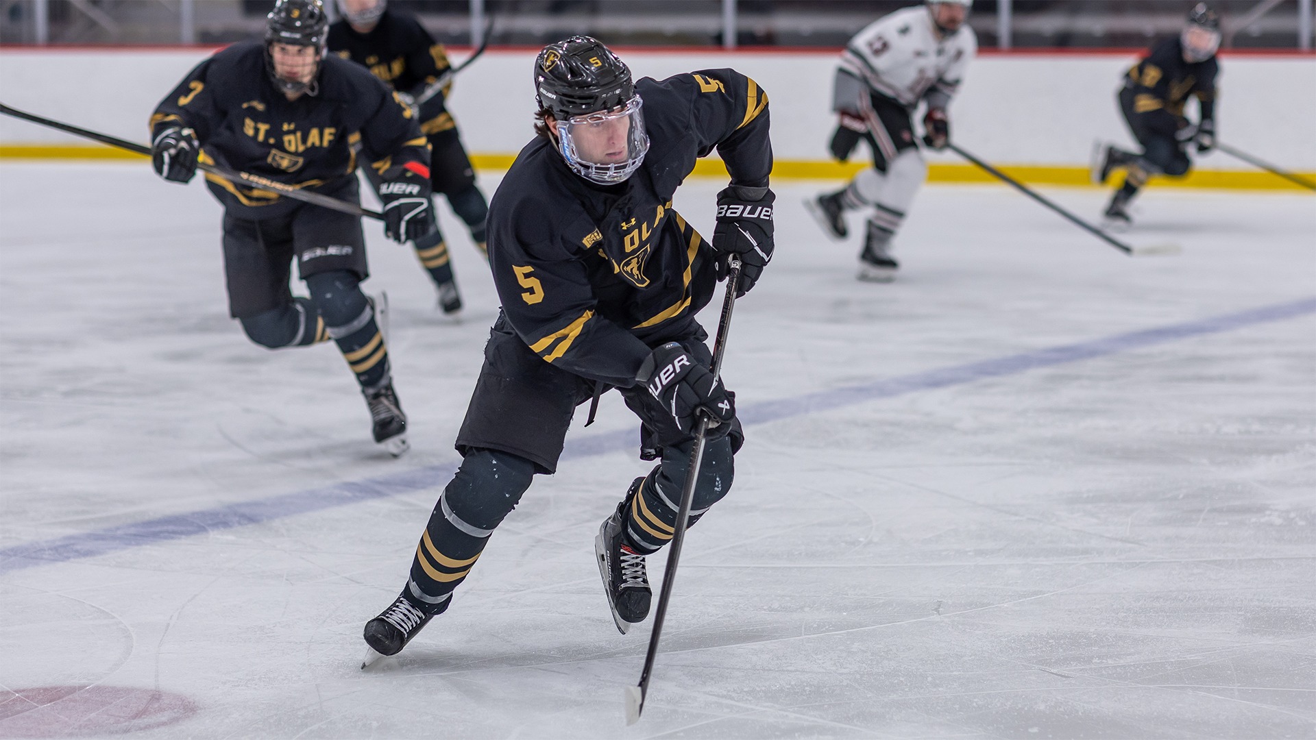 Camden Benson skates with the puck.
