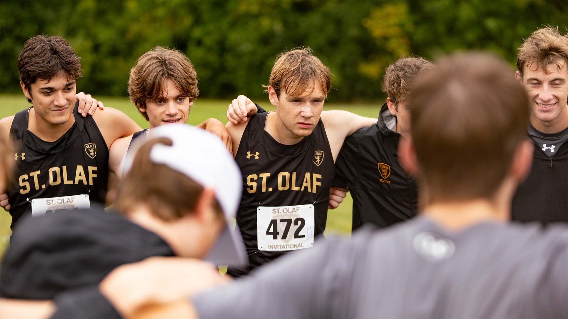 The St. Olaf men's cross country team huddles before a race.