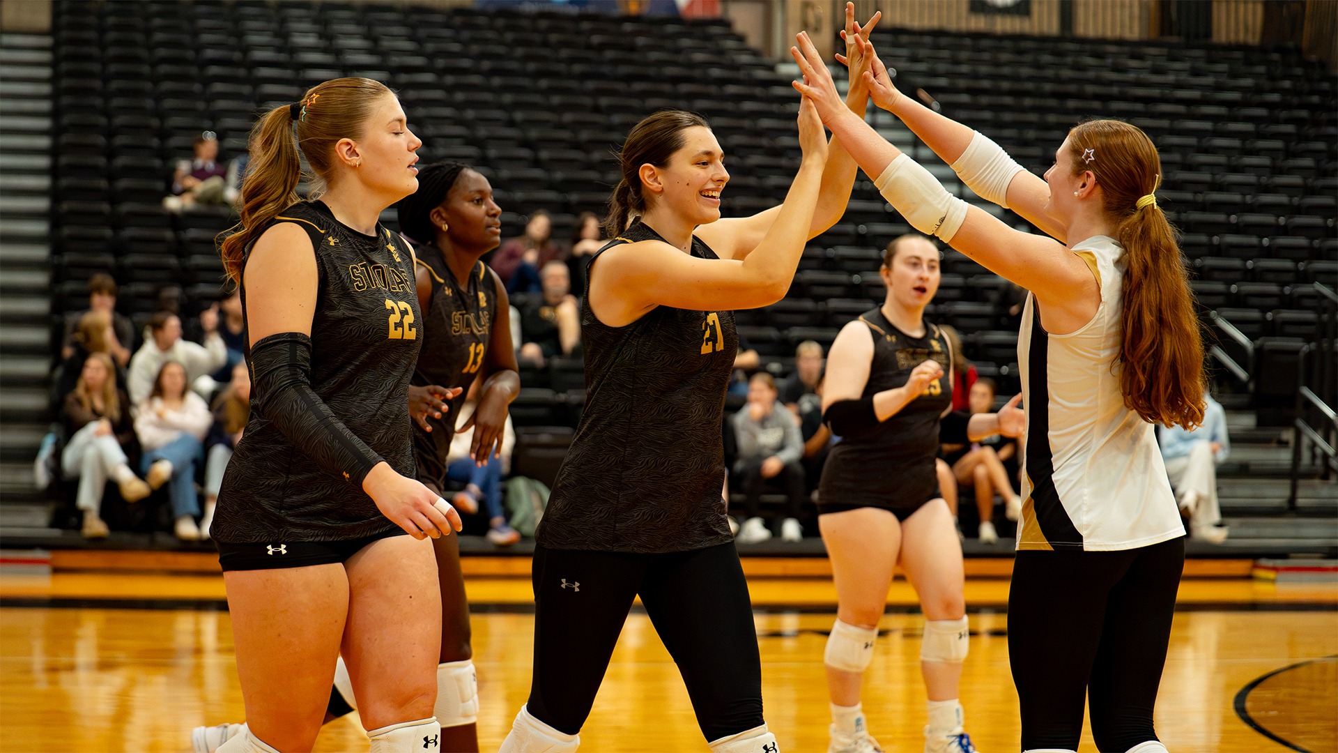 Lilah Van Scoyoc and Michaela Dooley high-five.