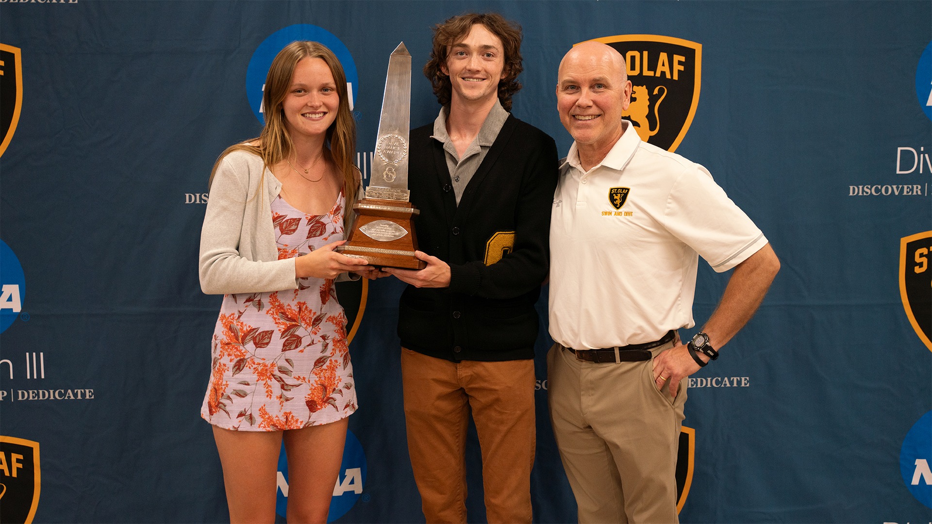 Kevin Turlington, Isabel Wyatt, and Bob Hauck pictured with the Hauck Award trophy.