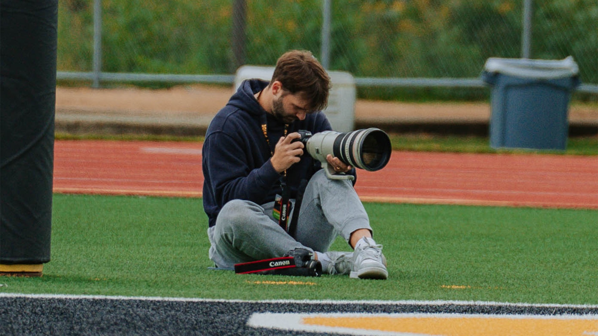 Mike Bostrom shoots photos at a football game.