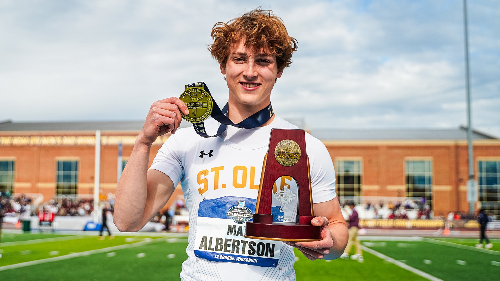Max Albertson holds his All-America trophy and medal.