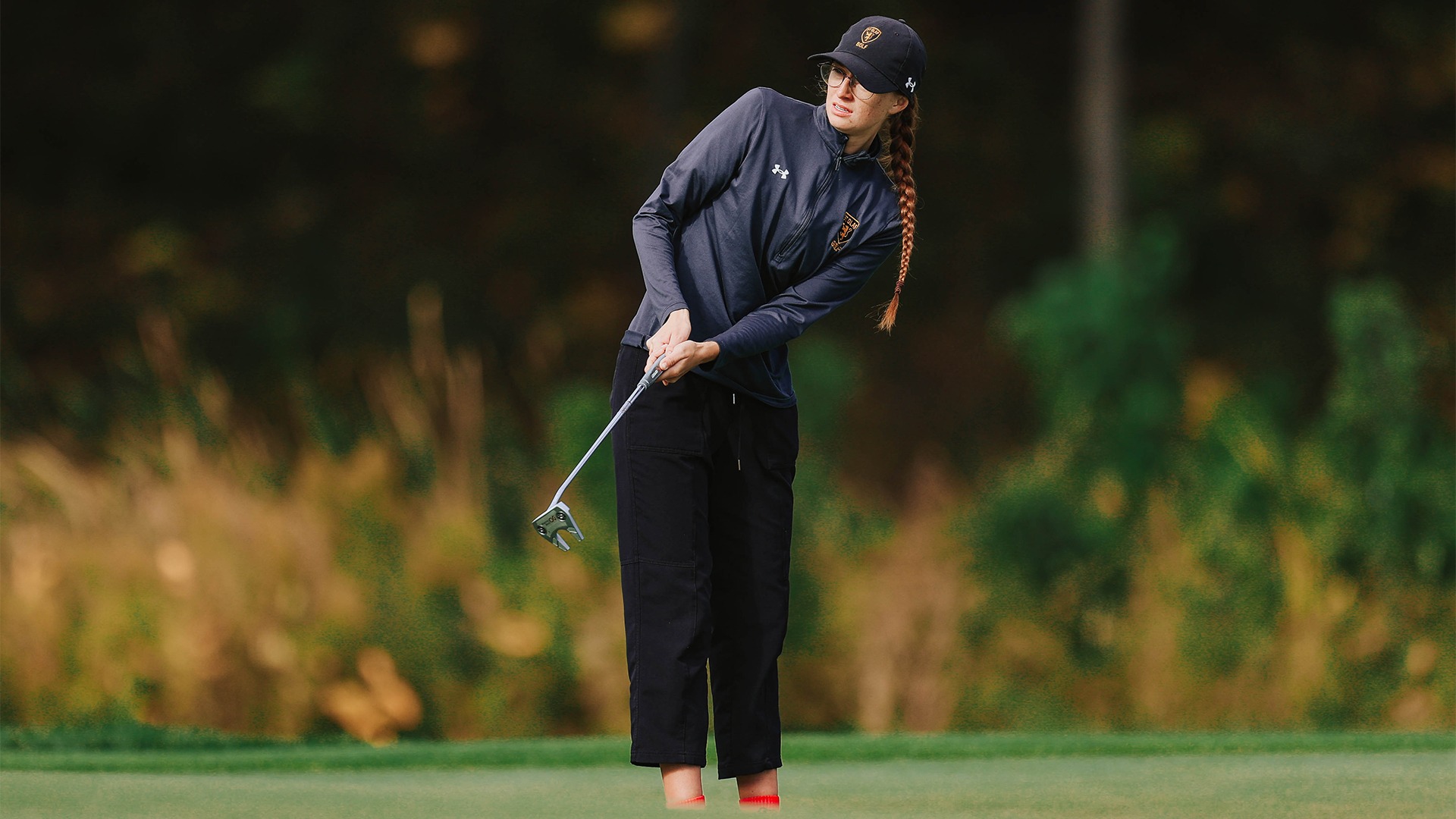 Belle Mae Williams watches a putt approach the hole.