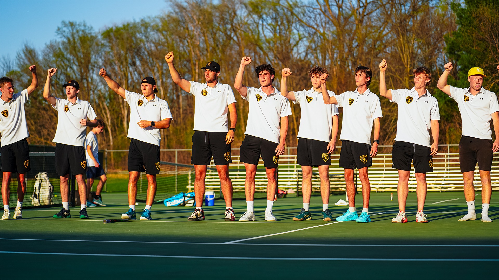 The men's tennis team sings Um! Yah! Yah! after a win.