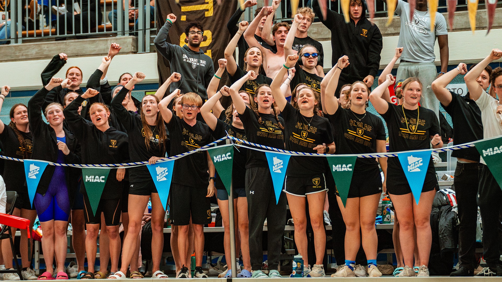 Members of the St. Olaf swimming and diving teams cheer on their teammates.