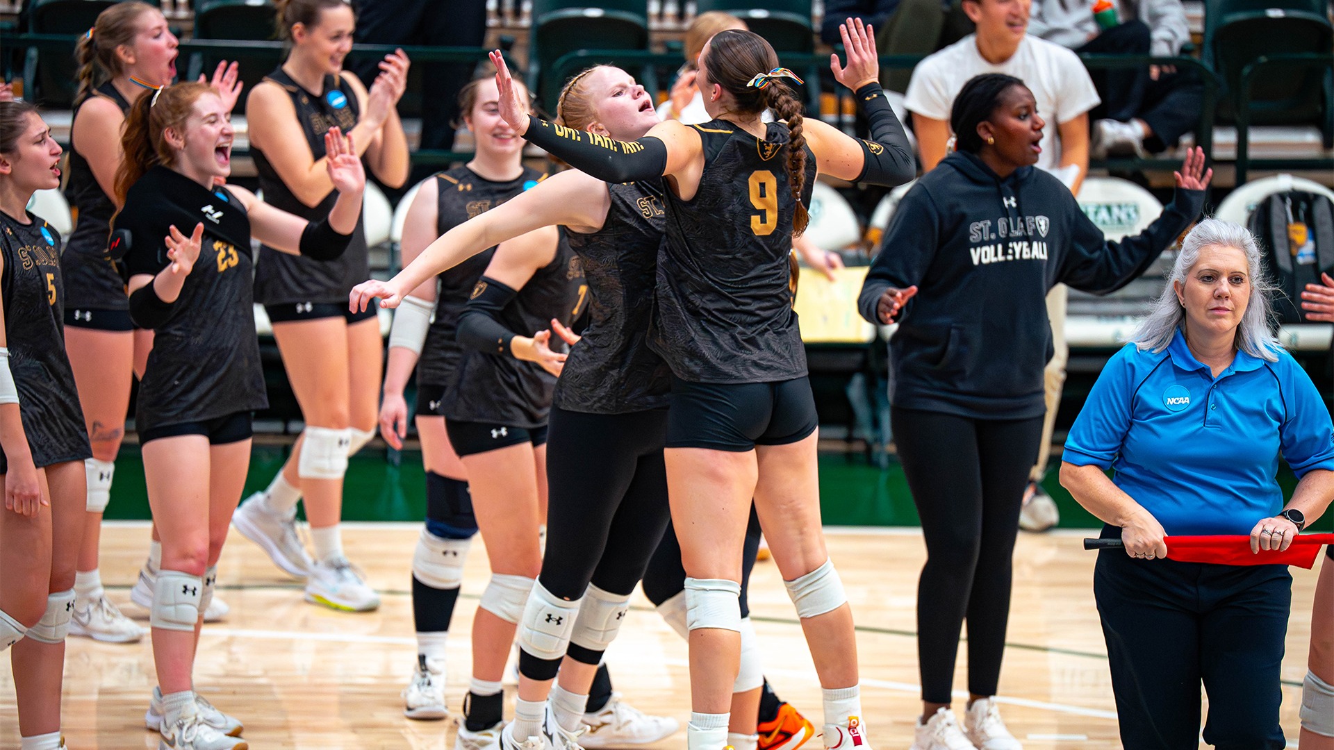 Mehsa Krause and Britta Hagen do a chest bump at a timeout.