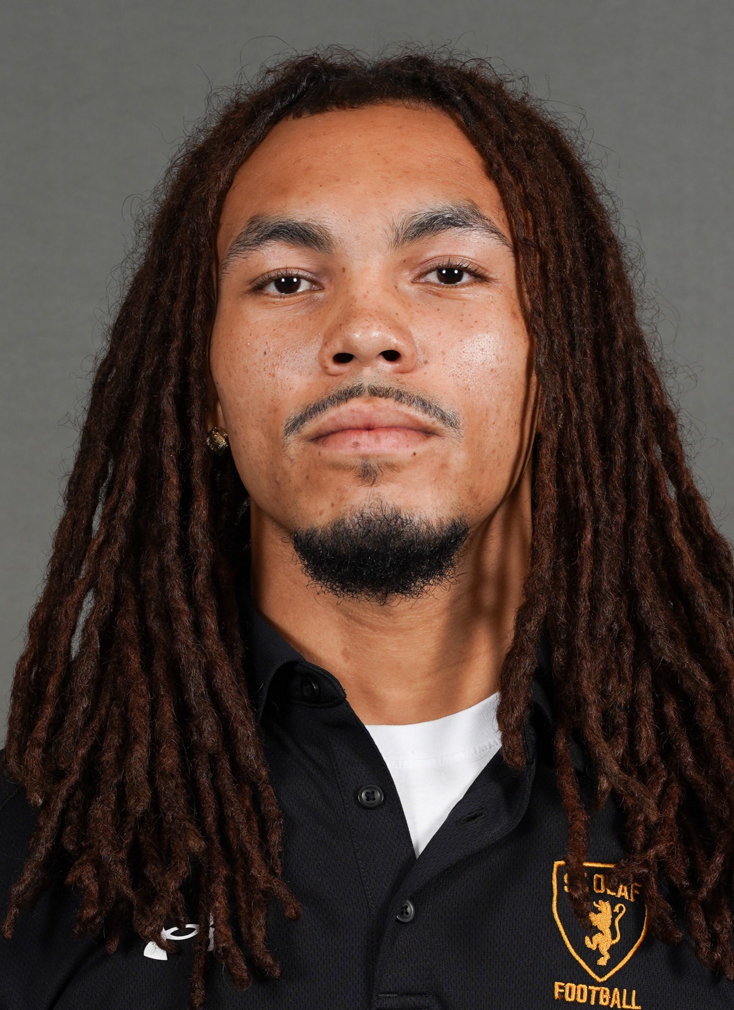 A headshot of student assistant football coach Angelo Wilson.