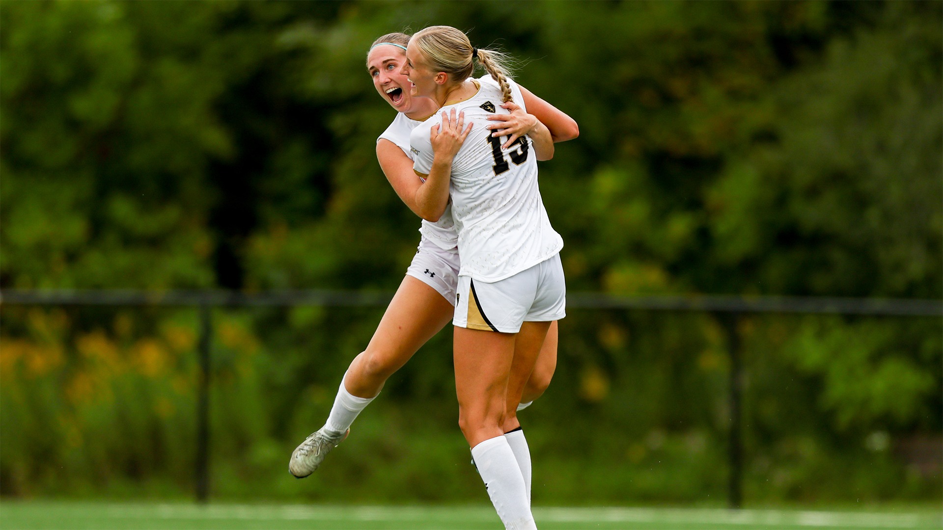 Anna Gilmer and Emily Johnson celebrate Gilmer's goal against Wartburg.