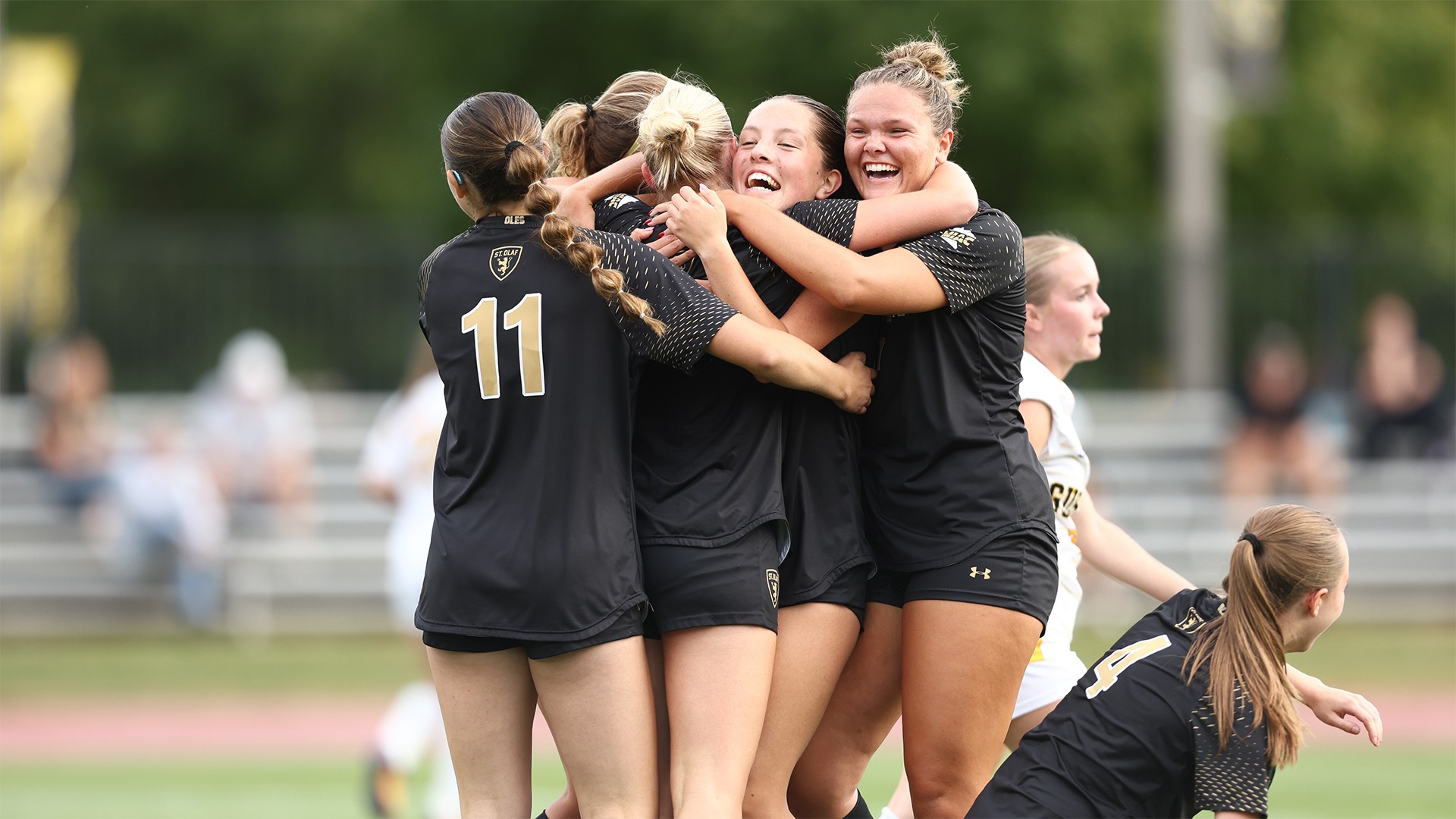 Women's soccer celebrates a goal.