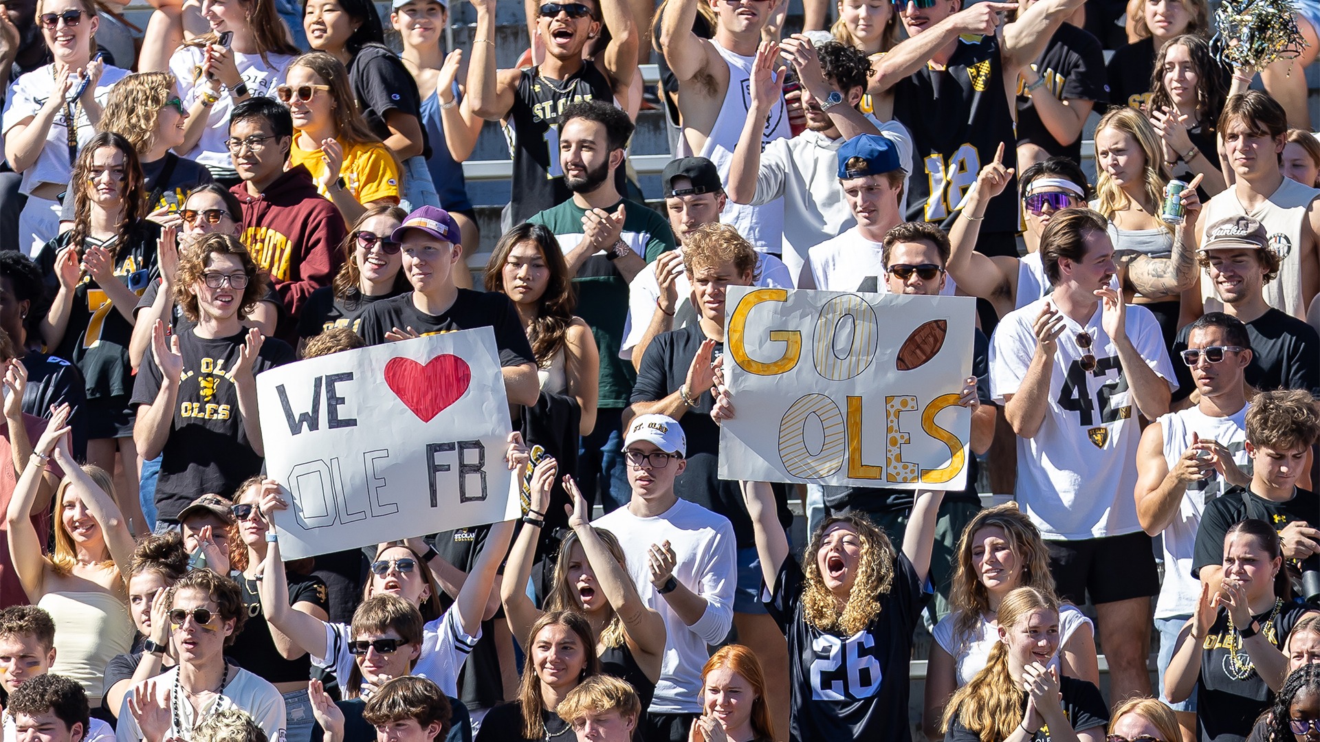 Fans cheer for the St. Olaf football team.