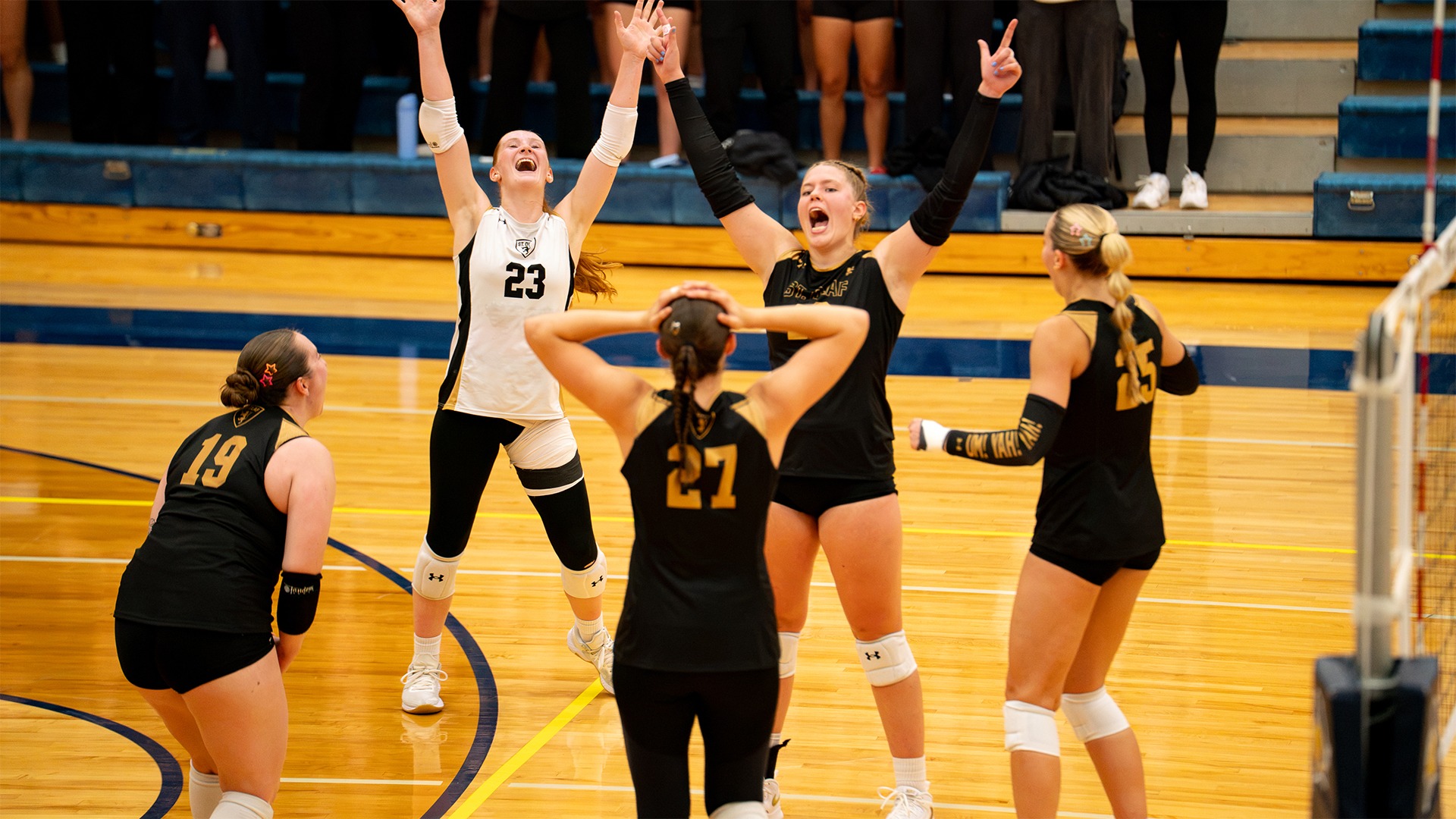The St. Olaf volleyball team celebrates winning a point.