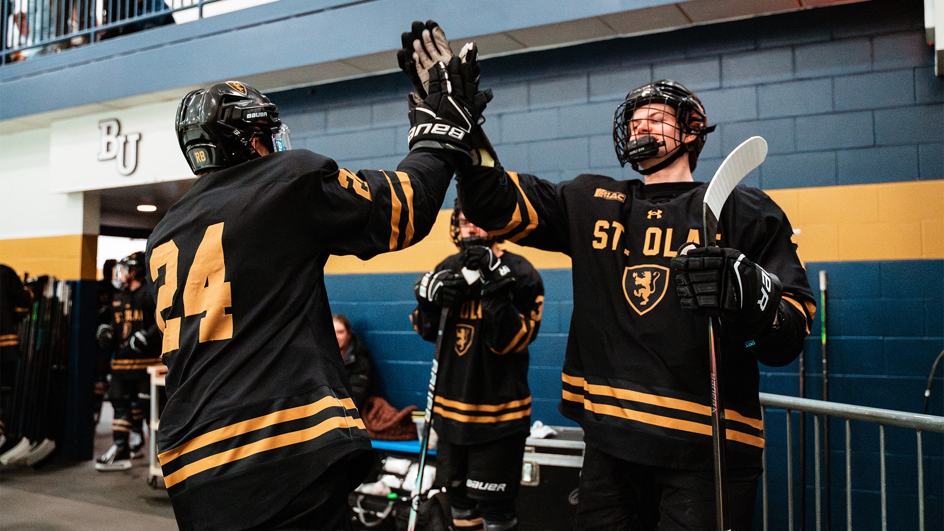 Members of the men's hockey team give each other a high-five.