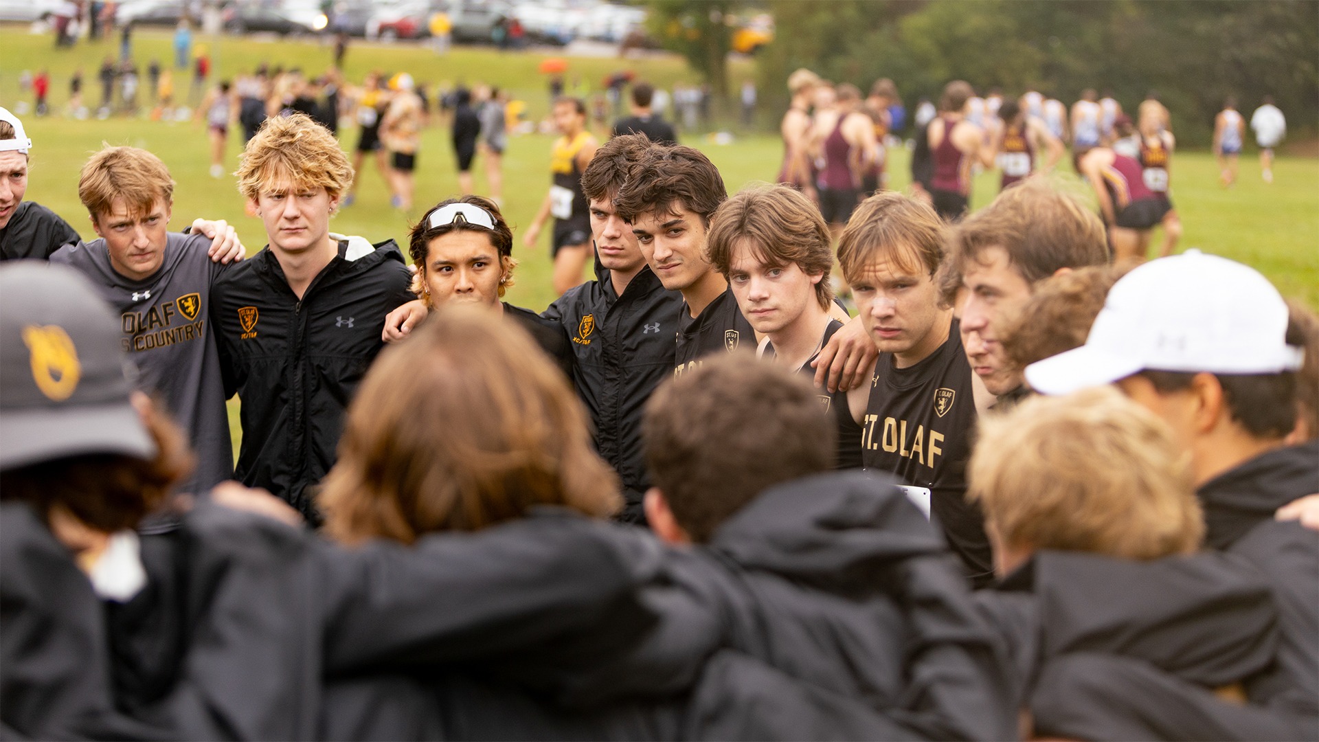 The St. Olaf men's cross country team huddles before a race.