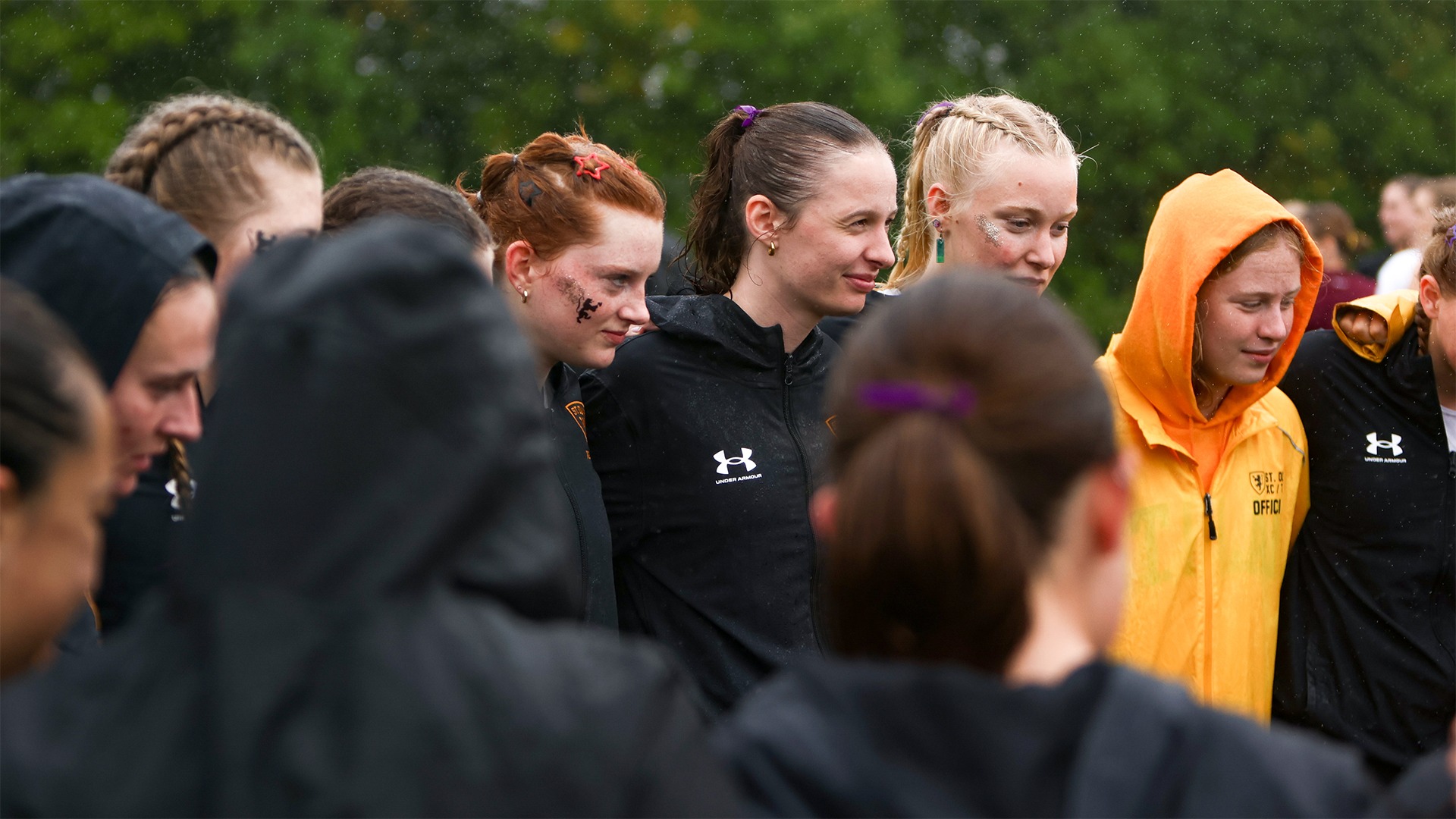 The St. Olaf women's cross country team huddles before a race.