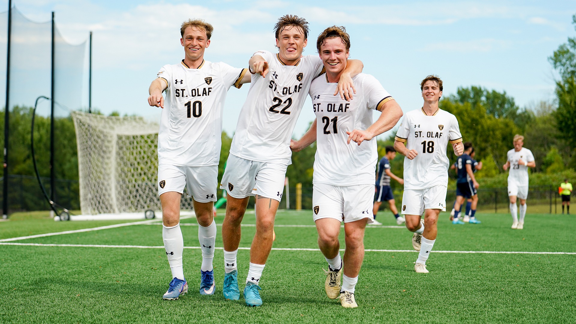 Lucas Montera, Charlie Piller, and Blaine Batchelor celebrate Batchelor's goal against Carroll.