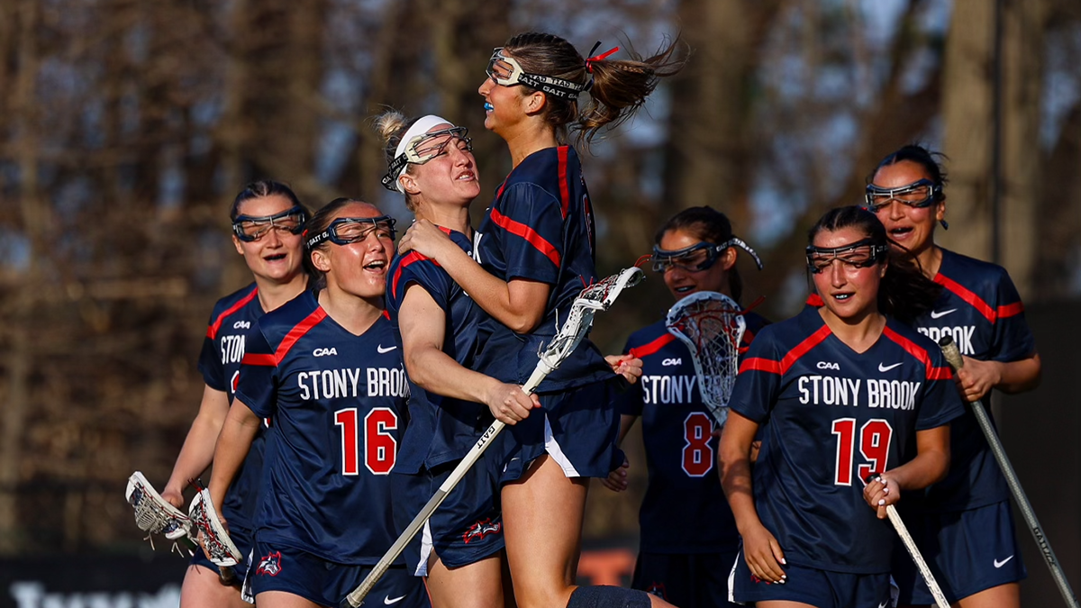 Stony Brook Women's lacrosse players Olivia Schorr celebrates a goal with a group of her teammates. 
