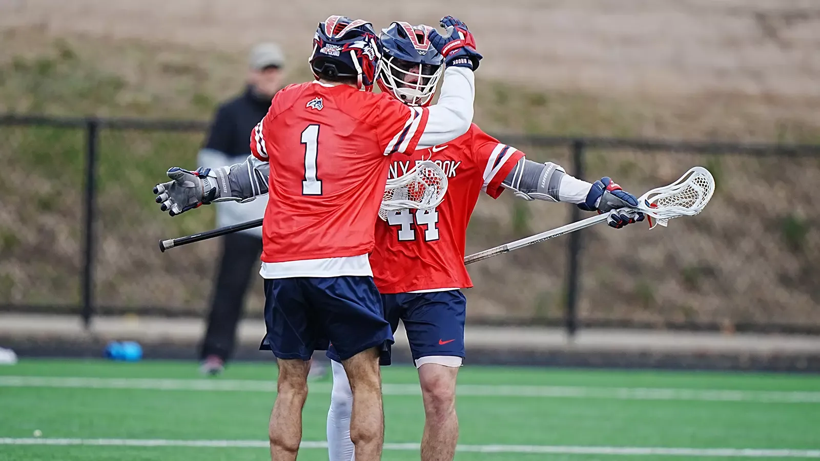 Stony Brook men's lacrosse players Justin Bonacci, and Owen Donnellan celebrate a goal together. 
