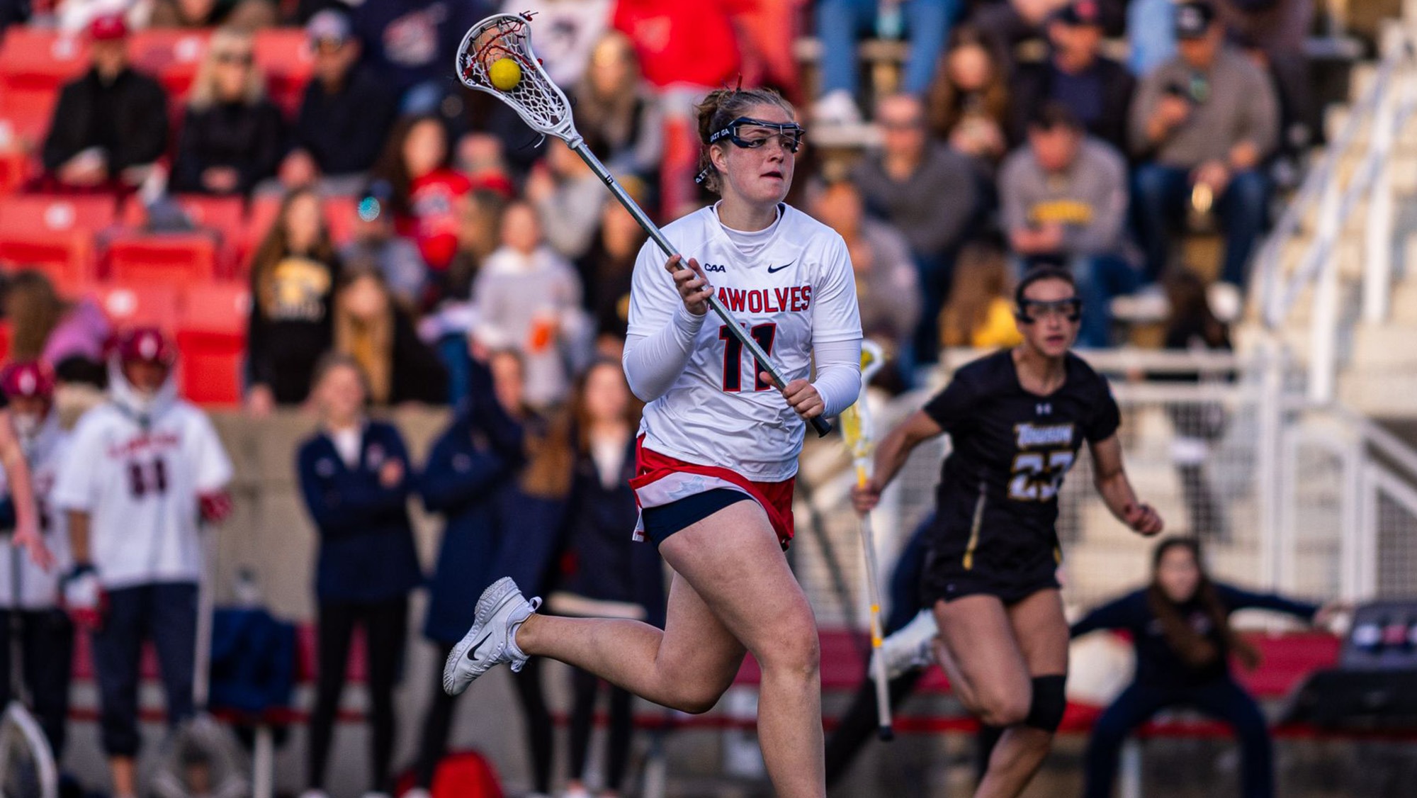 Stony Brook's Braeden Siverson runs forward, cradling a lacrosse stick with a ball in the crosse.