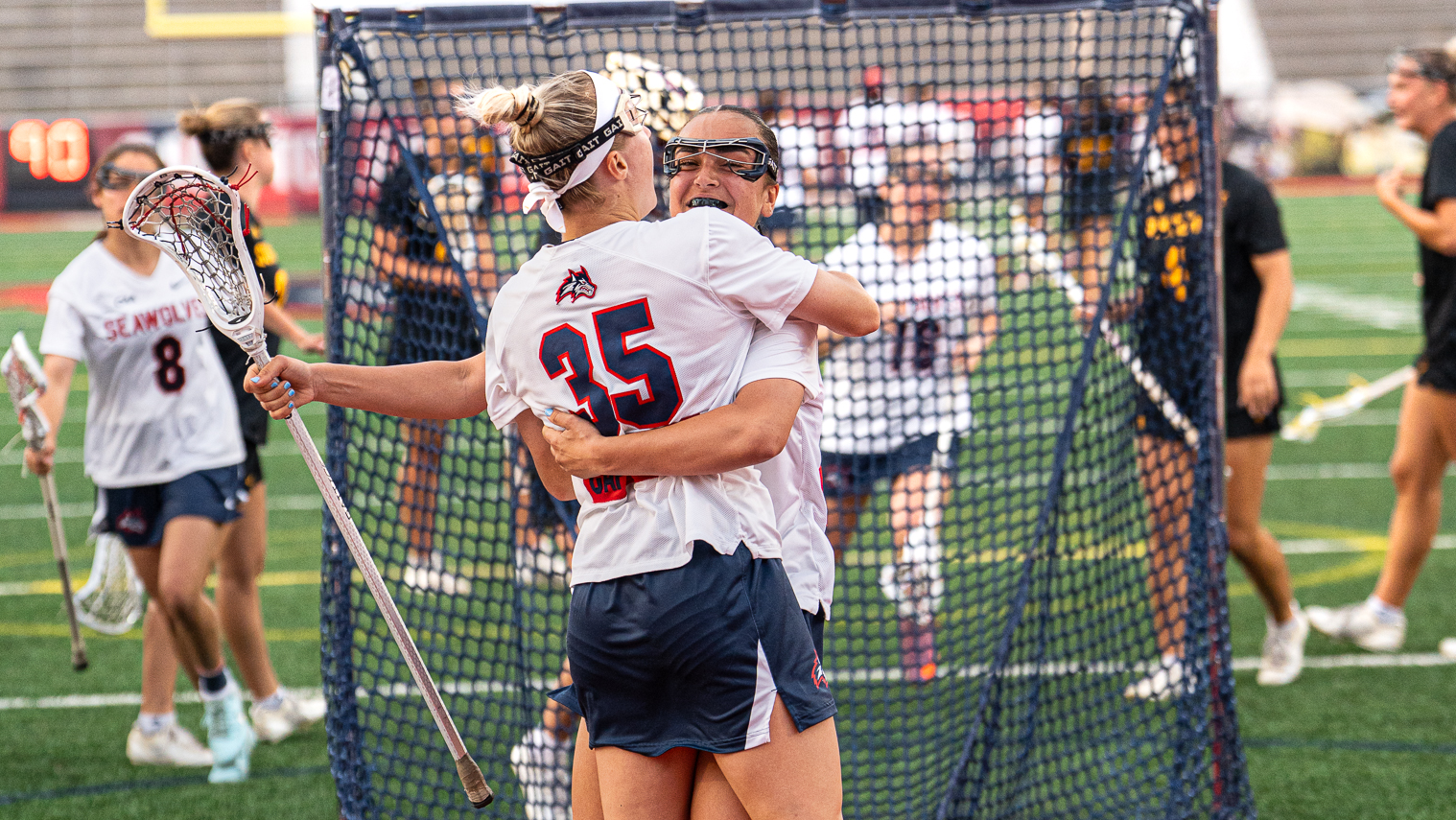 Stony Brook lacrosse players Isabella Caporuscio and Mirabella Altebrando celebrating a goal scored against Arizona State.