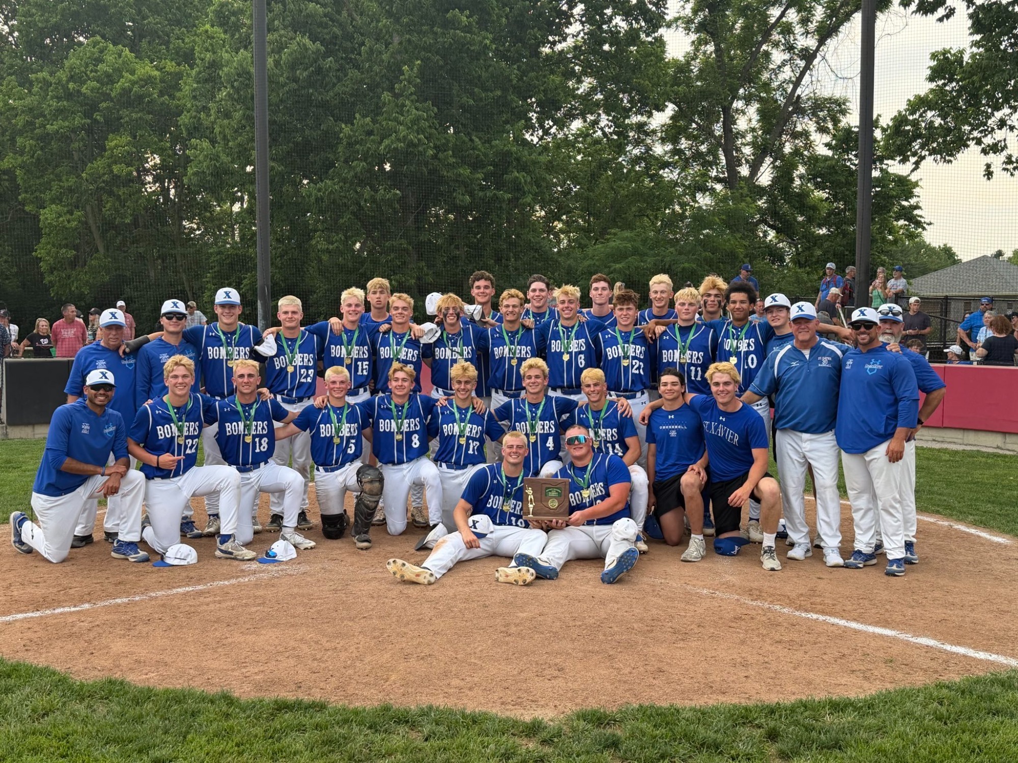 The Bomber Baseball team poses with the district trophy after defeating Lakota West 