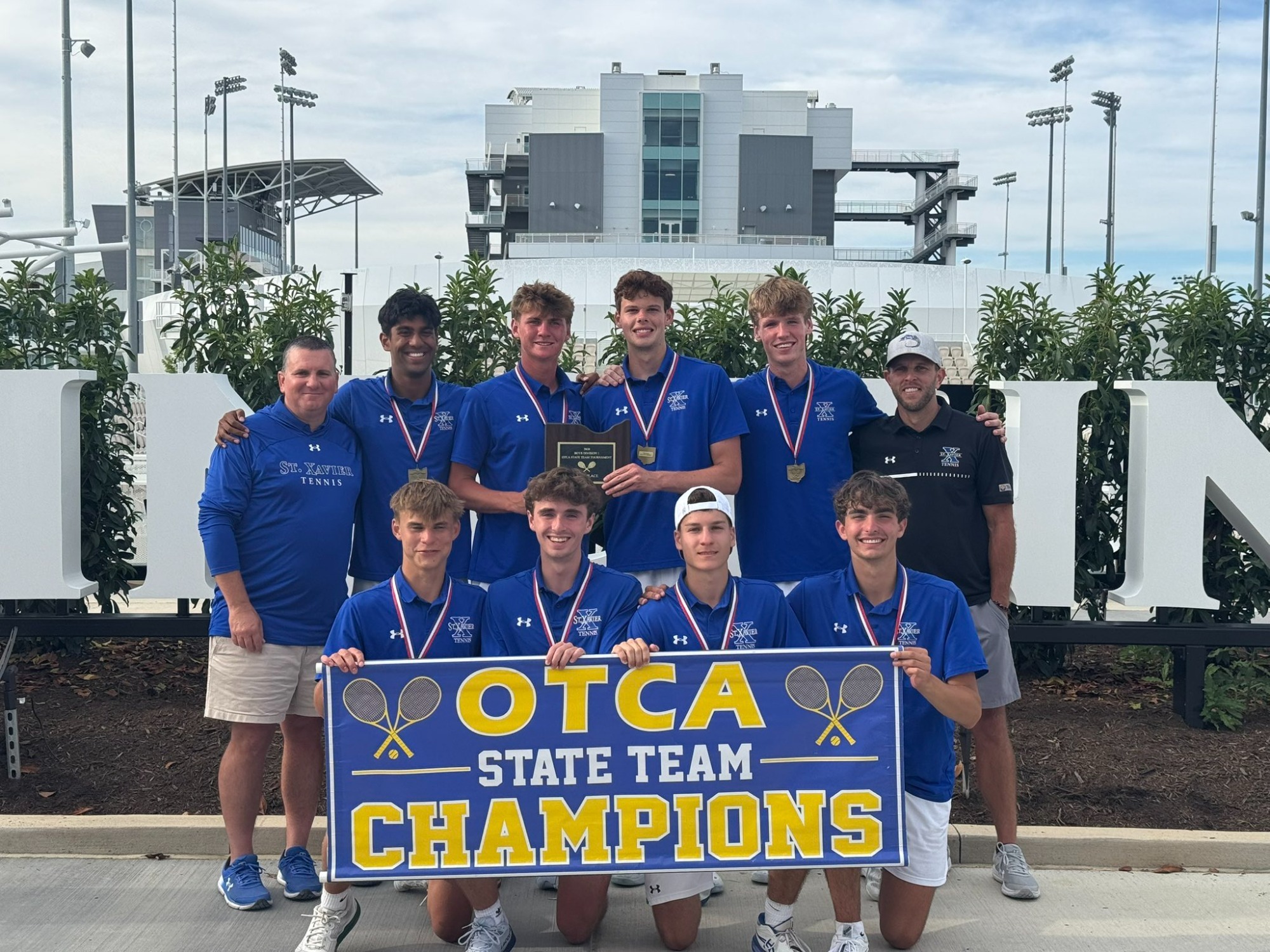 Bomber Tennis pose with banner after winning first OTCA team title since 2009 