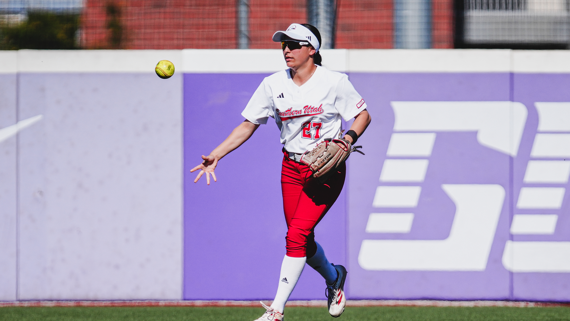 Alayah Toscano tosses the ball in after the third out
