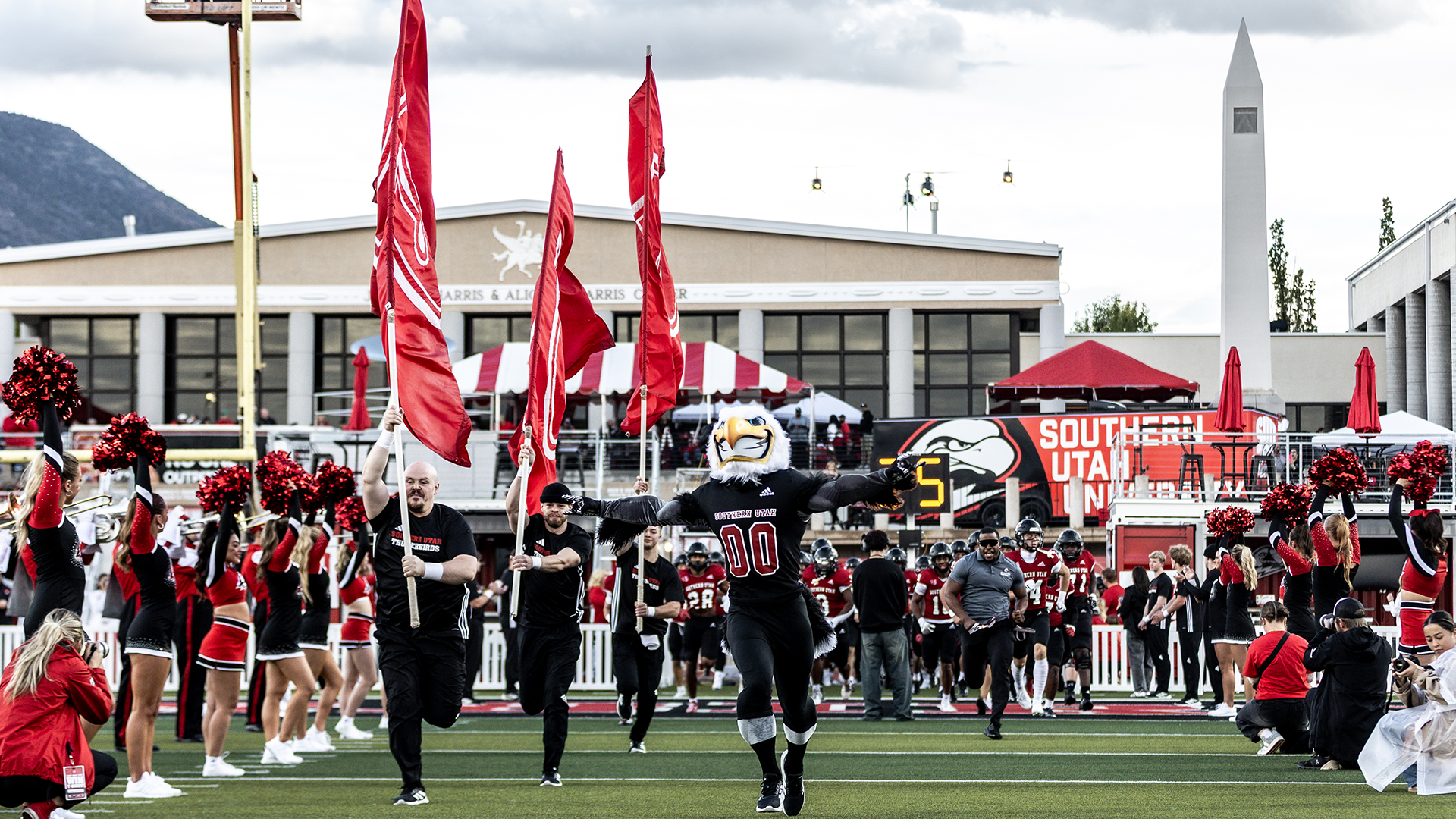 Thor leading the football team out onto the field at homecoming game