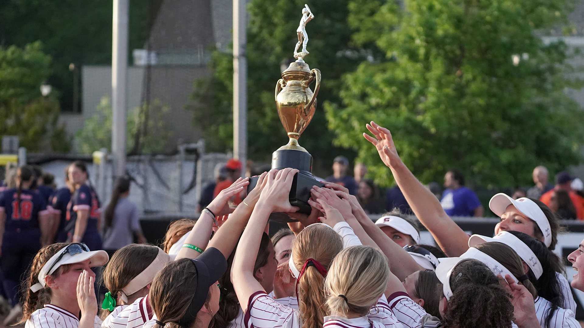 Softball lifting 2025 Centennial Championship trophy