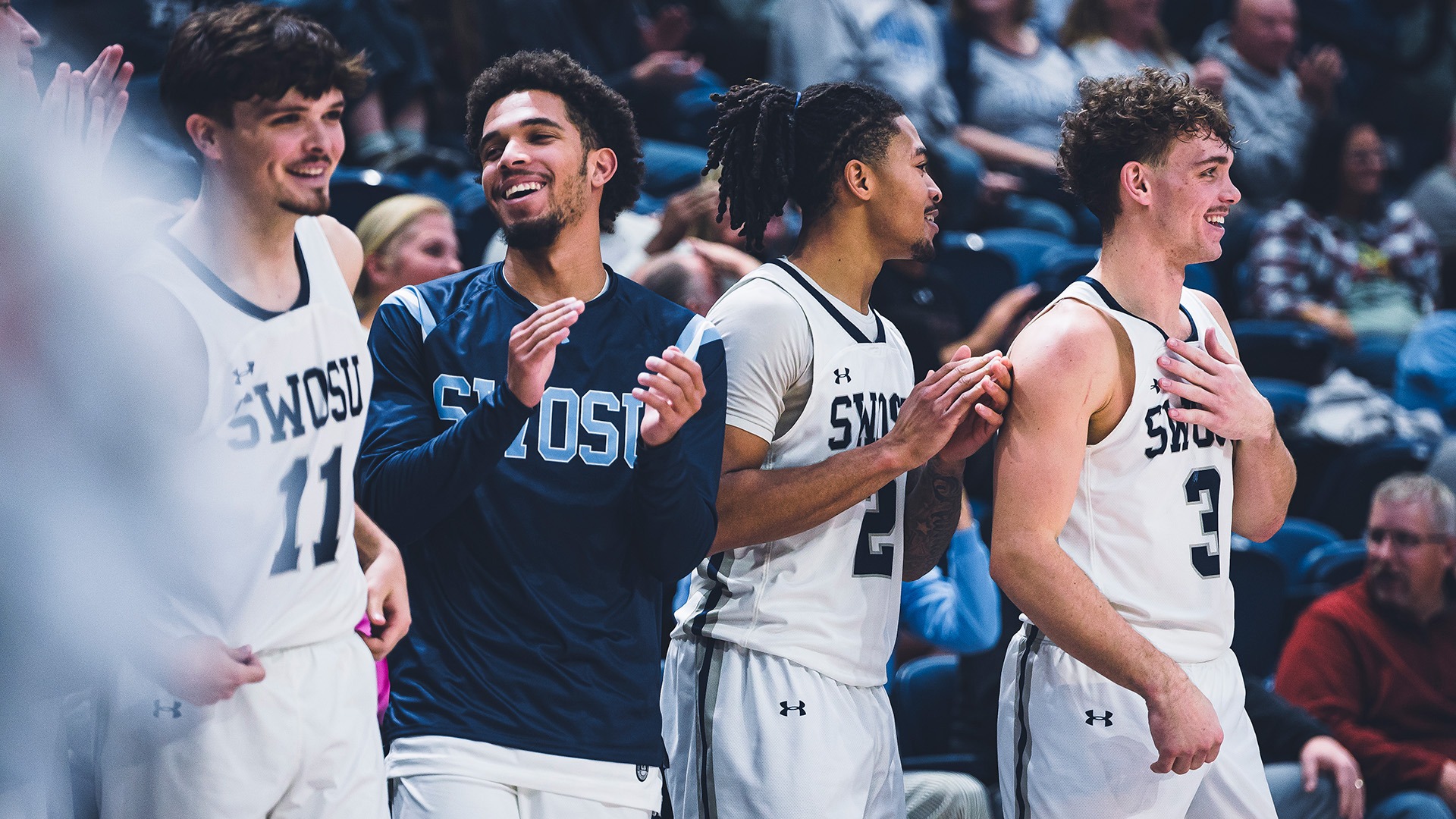 men's basketball bench smiling